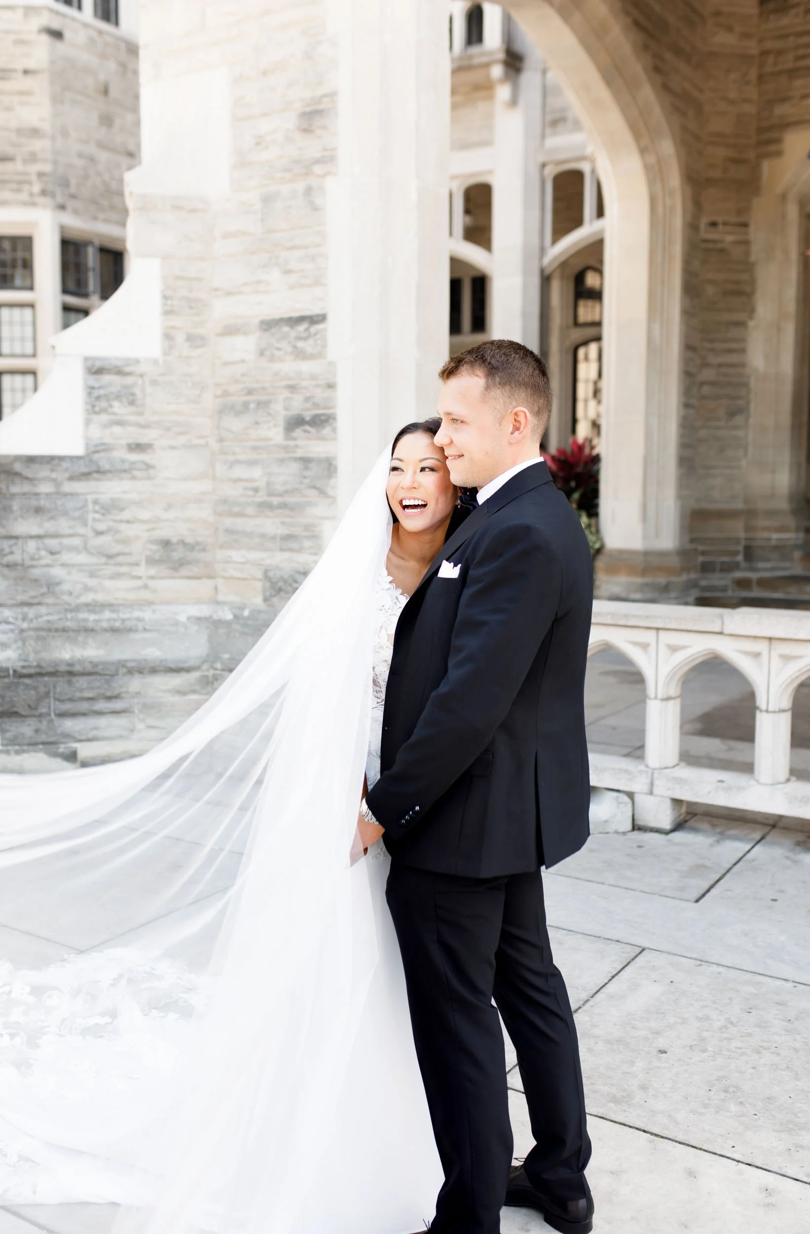Bride and groom standing in the Casa Loma courtyard in Toronto