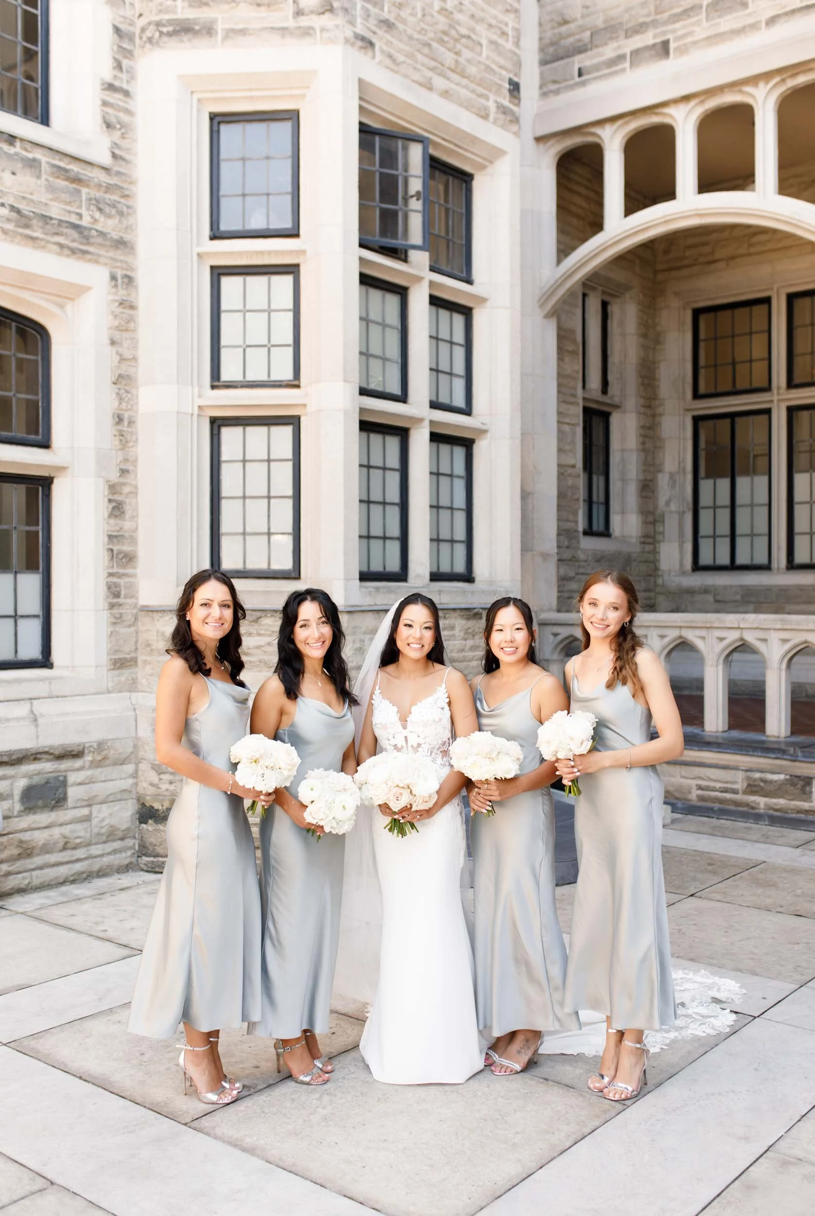 Bridesmaids holding bouquets at Casa Loma in Toronto