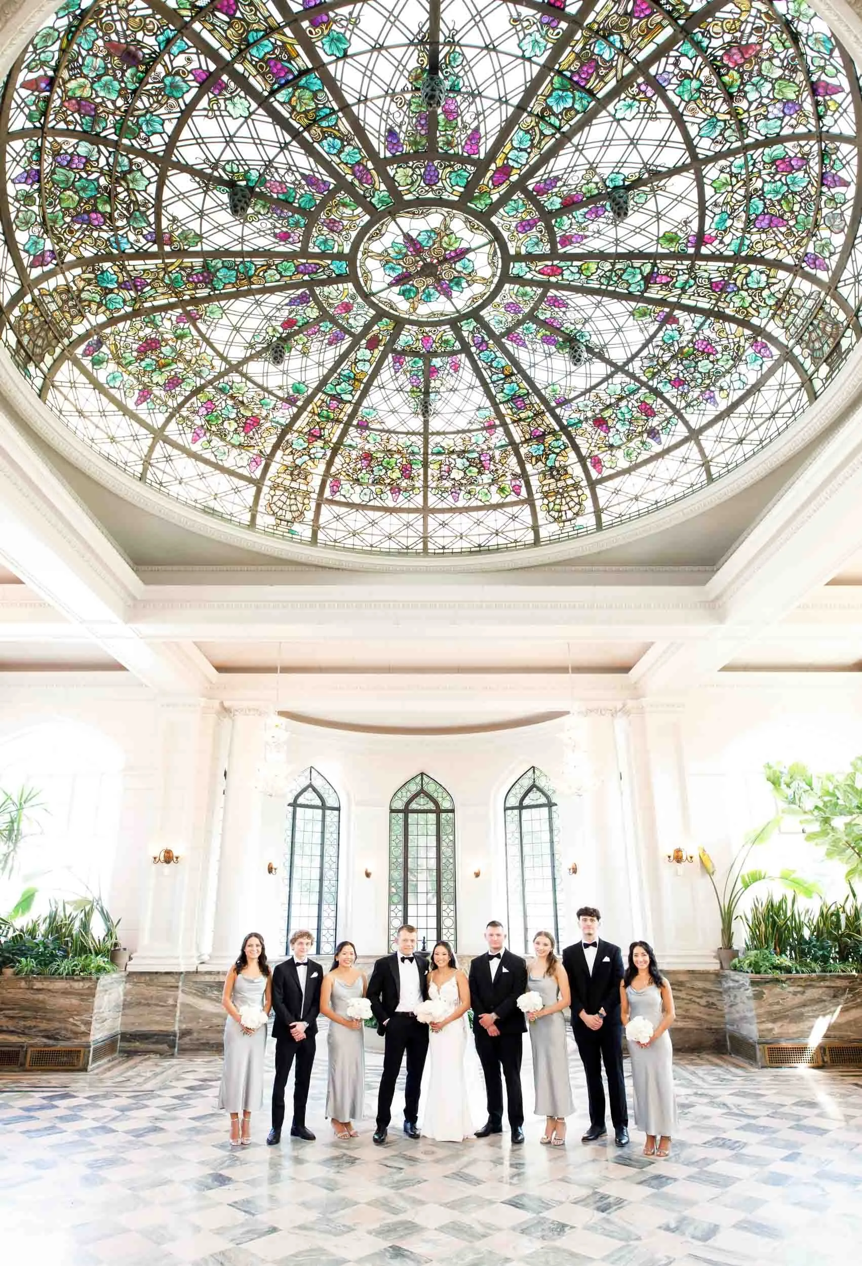 Stained glass dome and wedding party inside Casa Loma in Toronto
