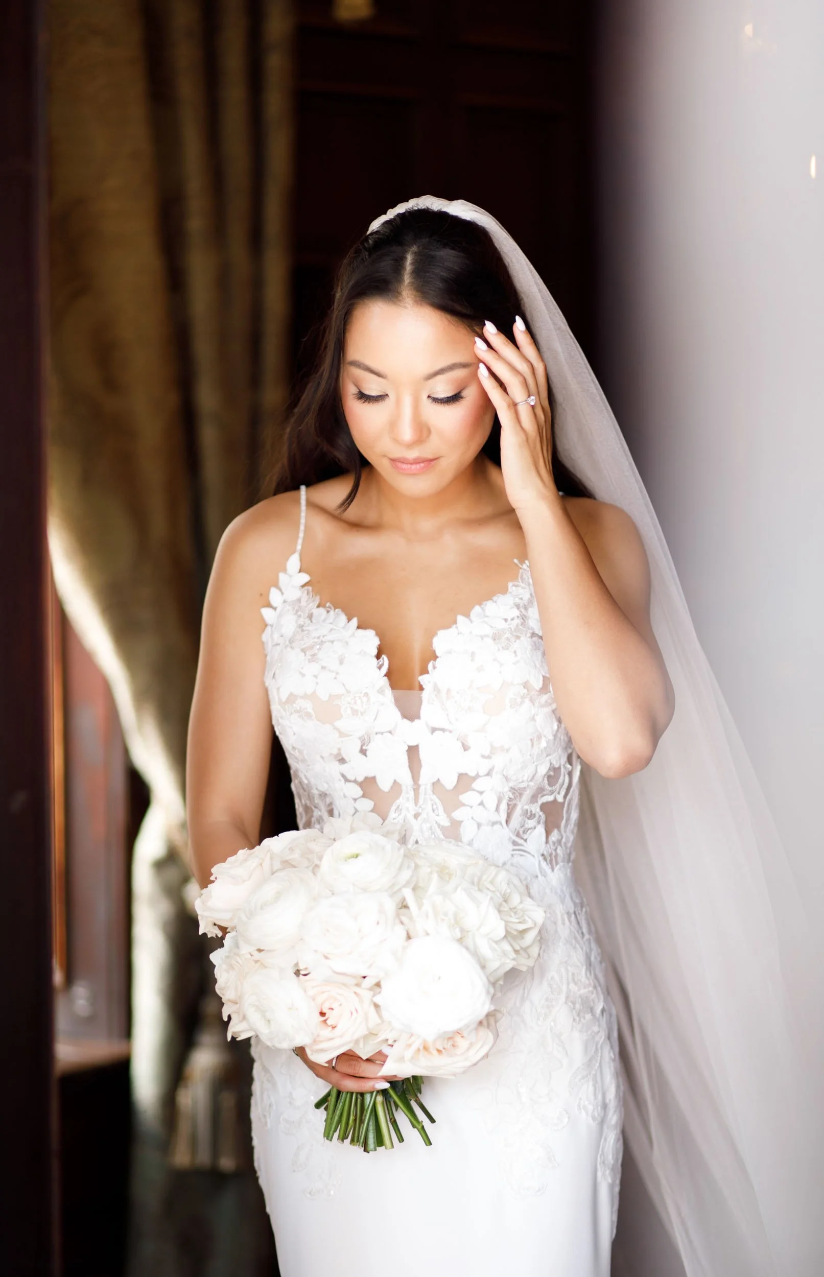 Bride adjusting her veil inside Casa Loma