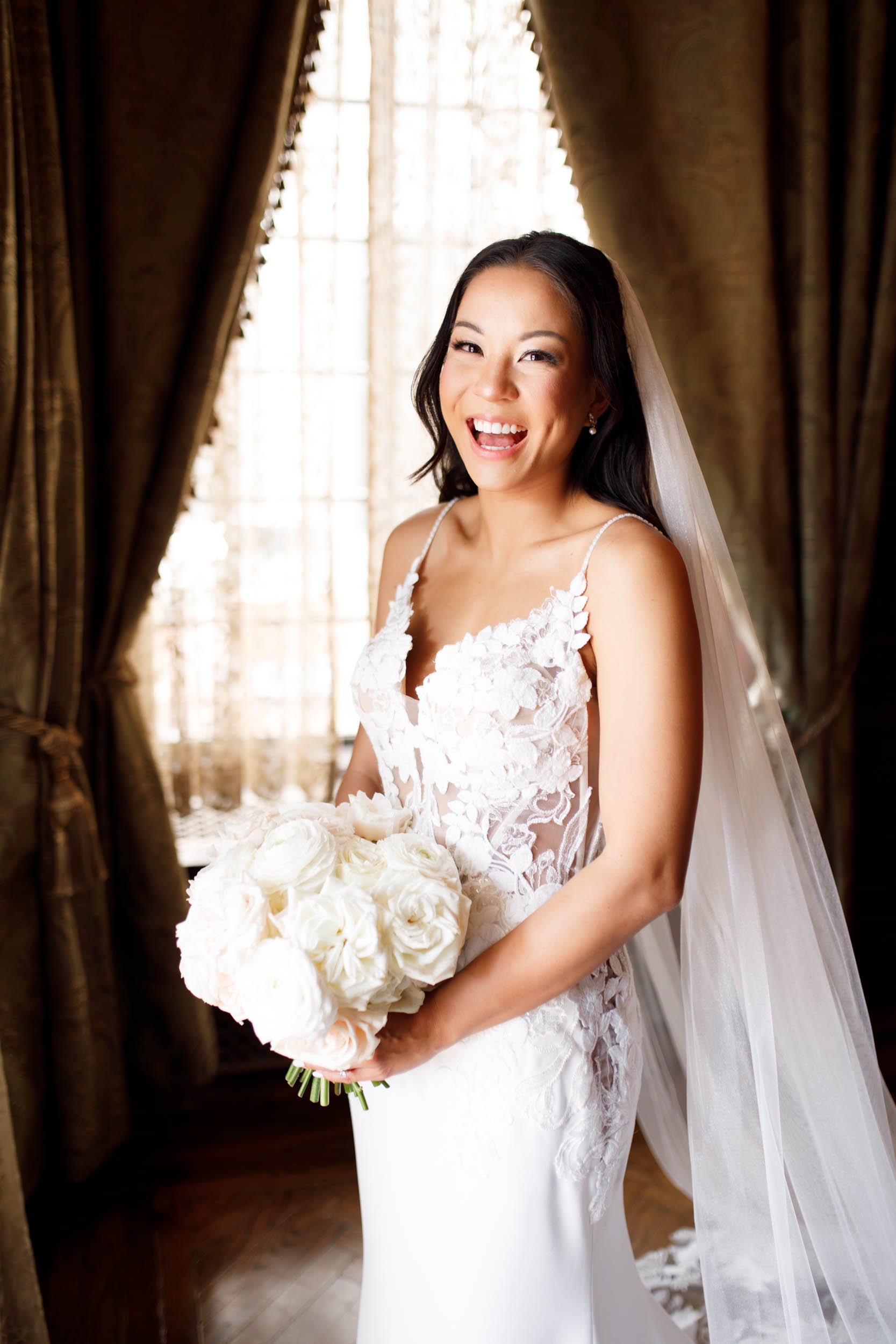 Bride portrait smiling with her bouquet at Casa Loma