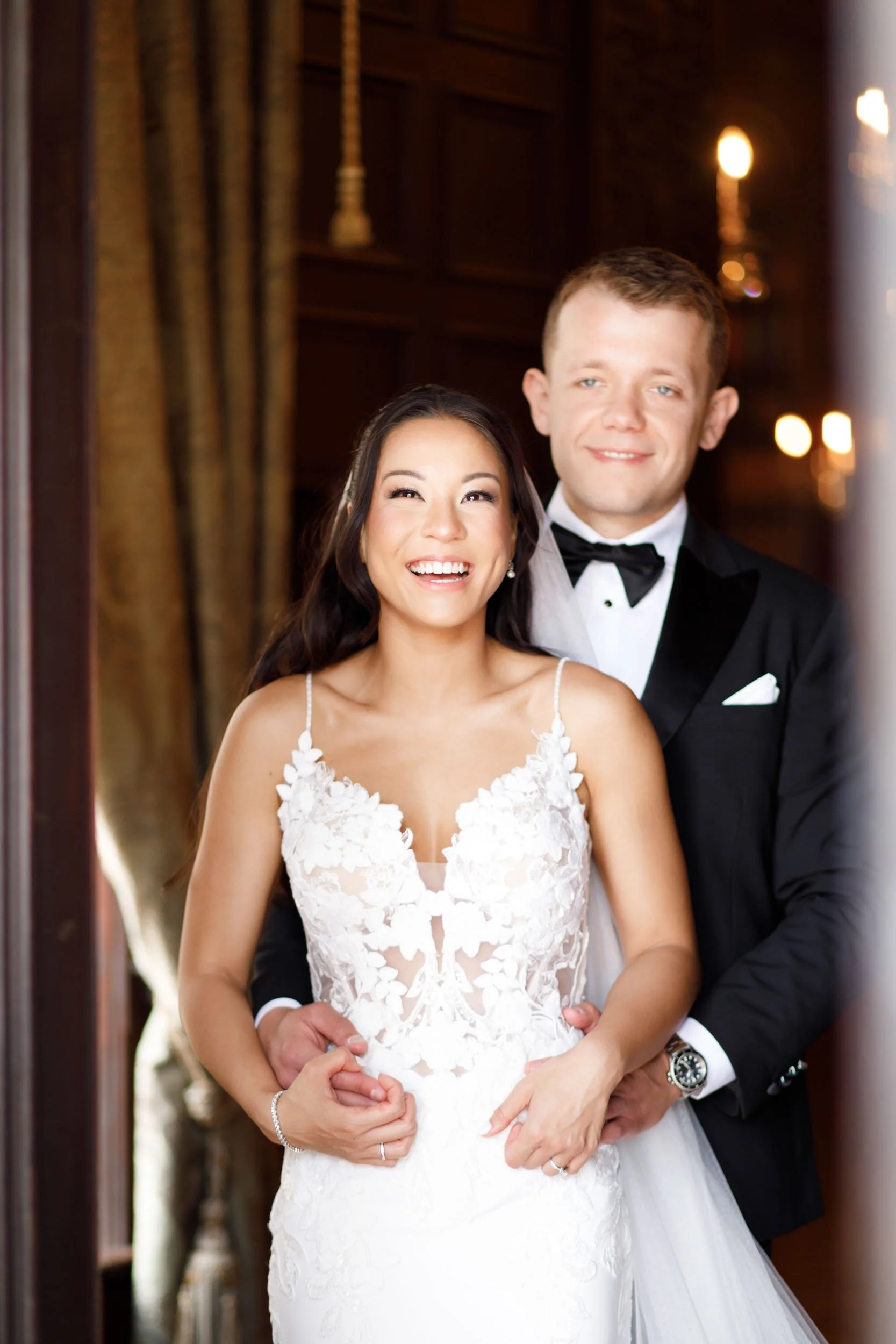Bride and groom posing together inside Casa Loma