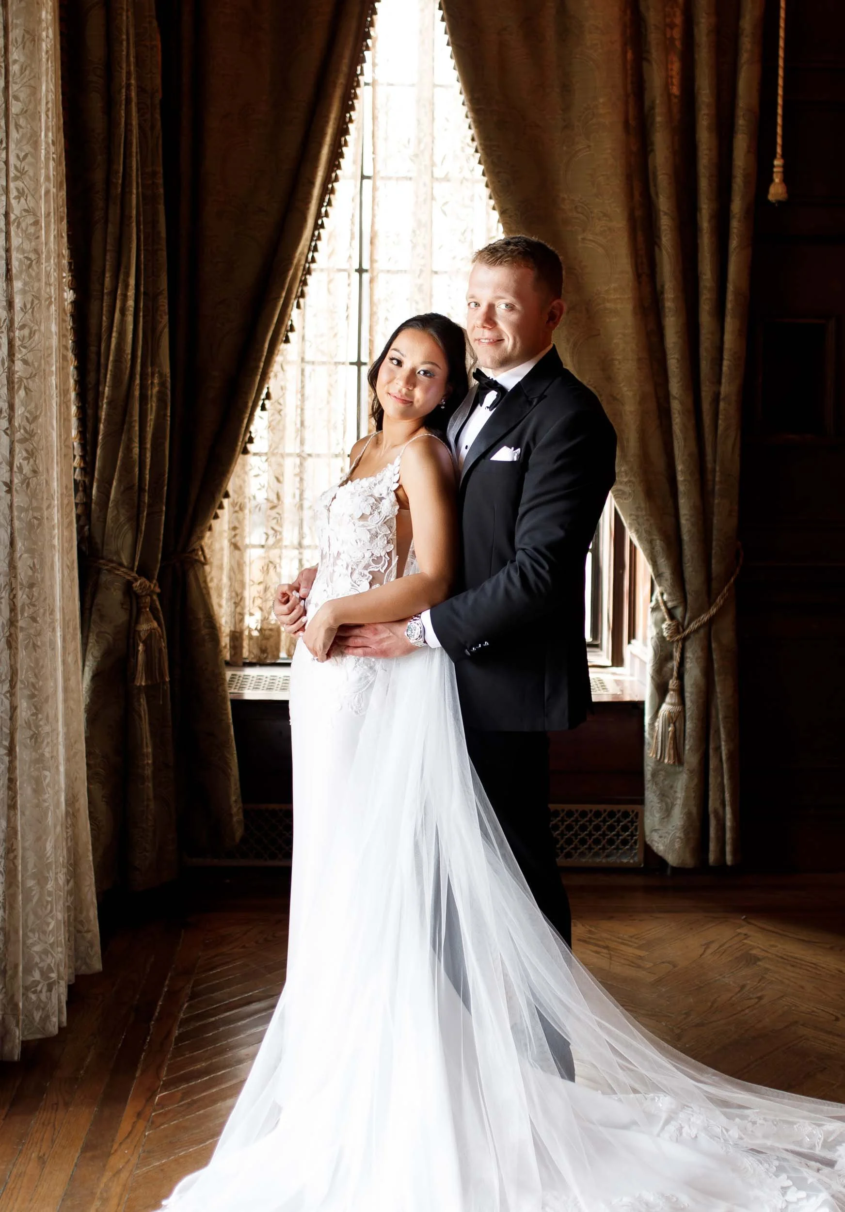 Bride and groom standing together inside Casa Loma in Toronto