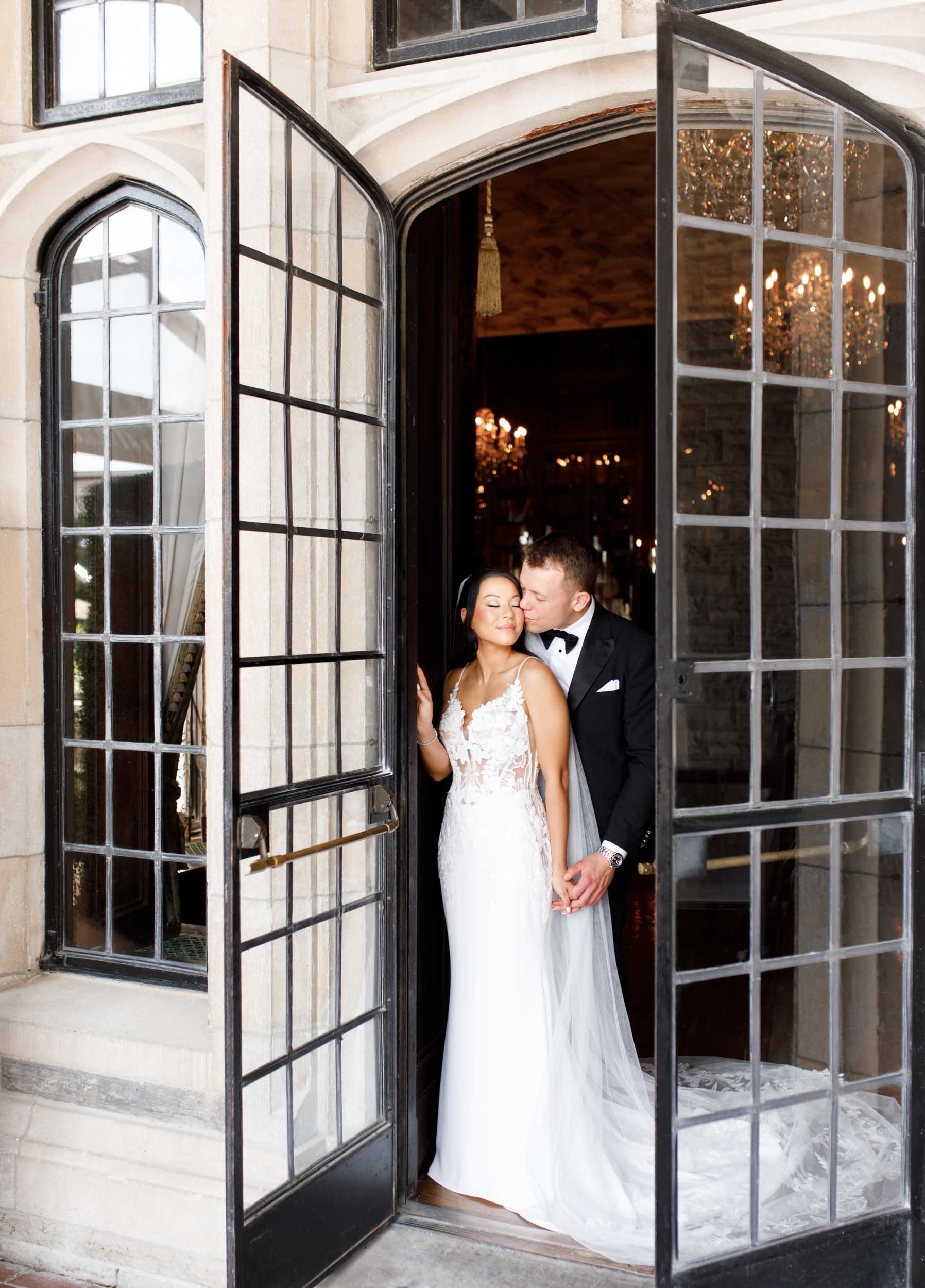 Bride and groom standing in the doorway at Casa Loma during their Toronto wedding