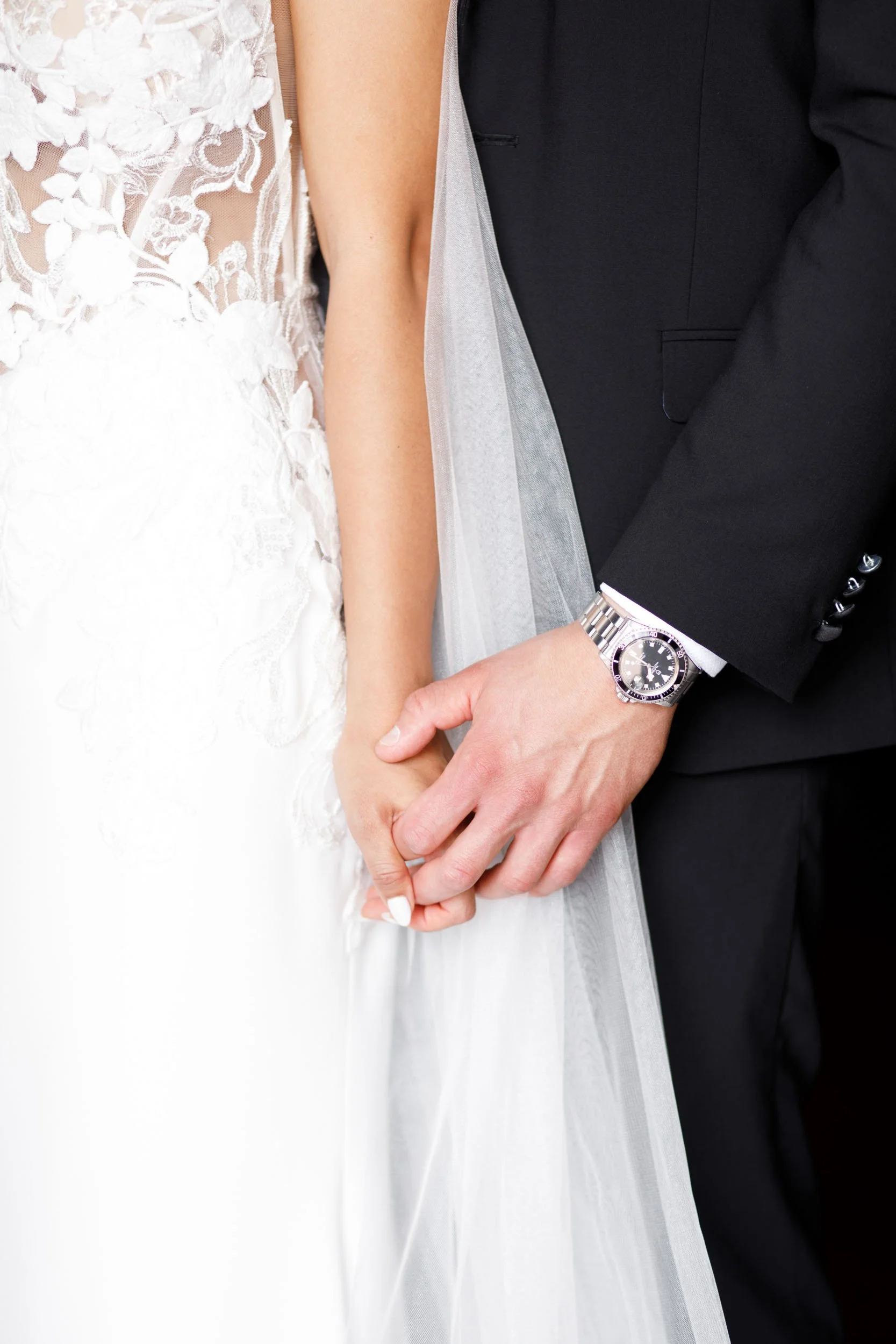 Close-up of the bride and groom holding hands at Casa Loma