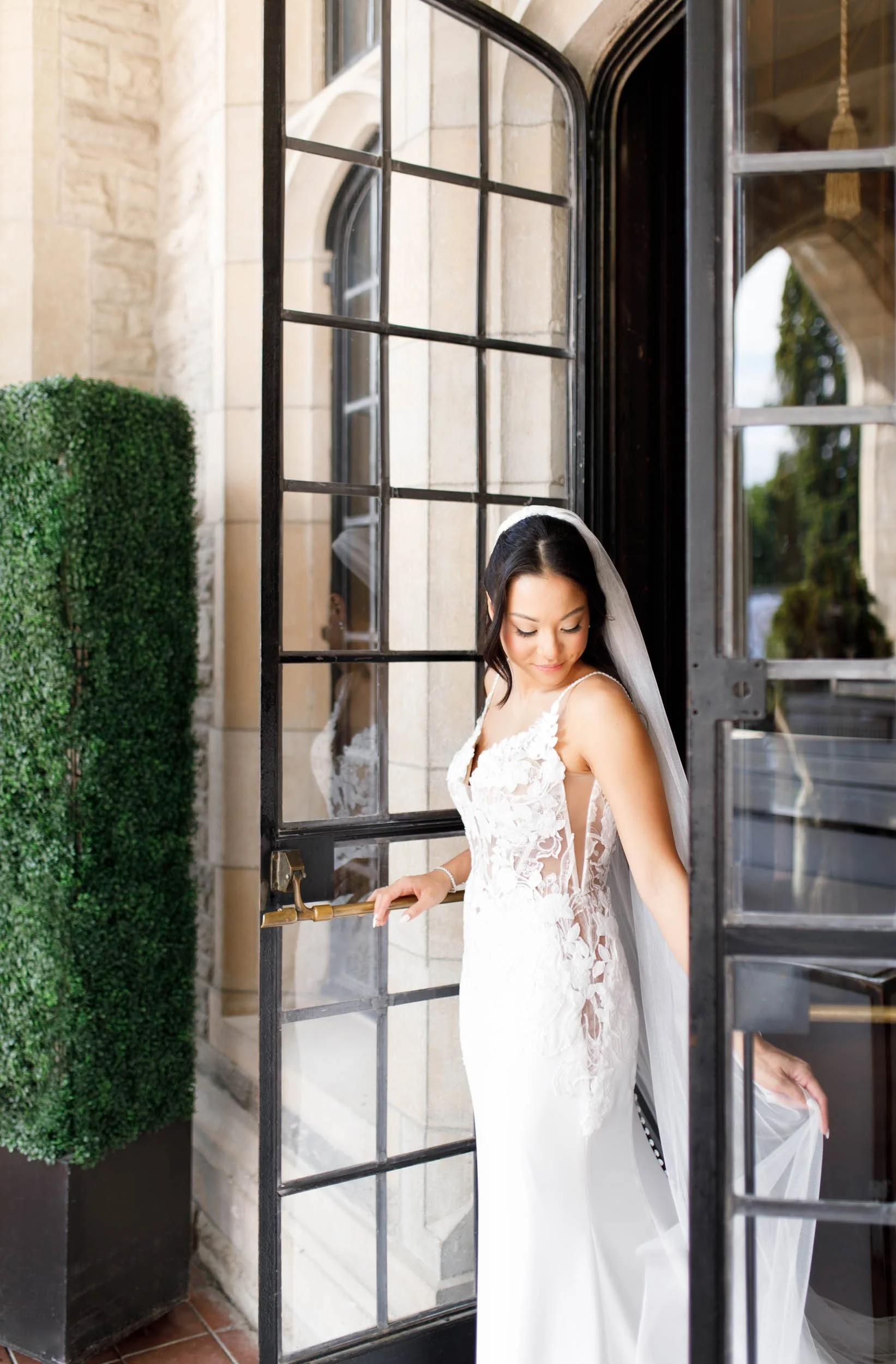 Bride flowing veil out of the Casa Loma entrance