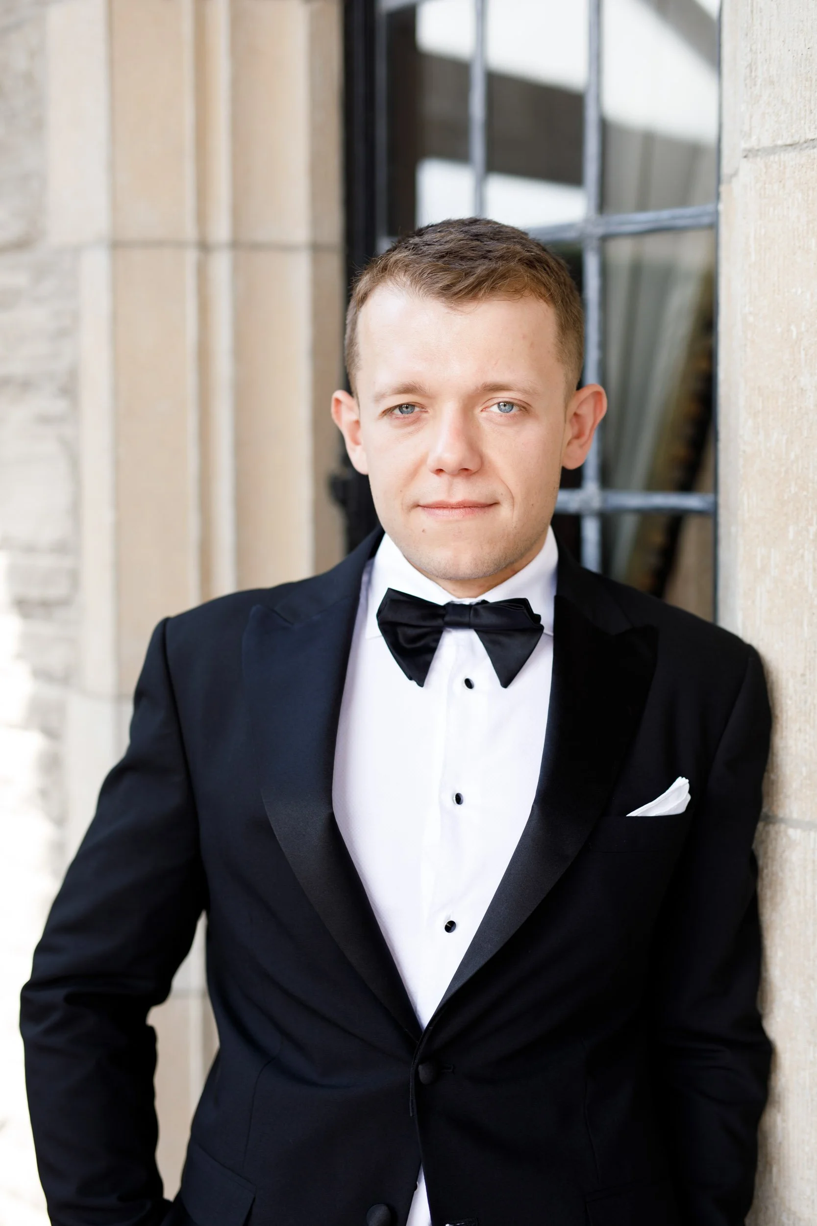 Groom posing outside Casa Loma