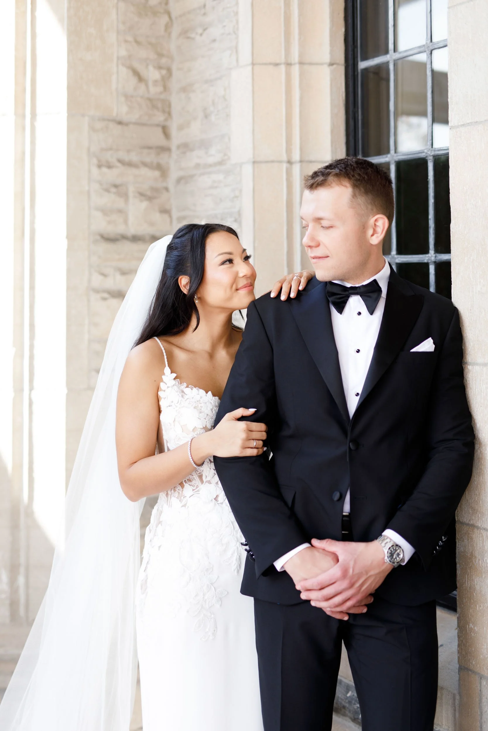 Bride and groom smiling together outside Casa Loma