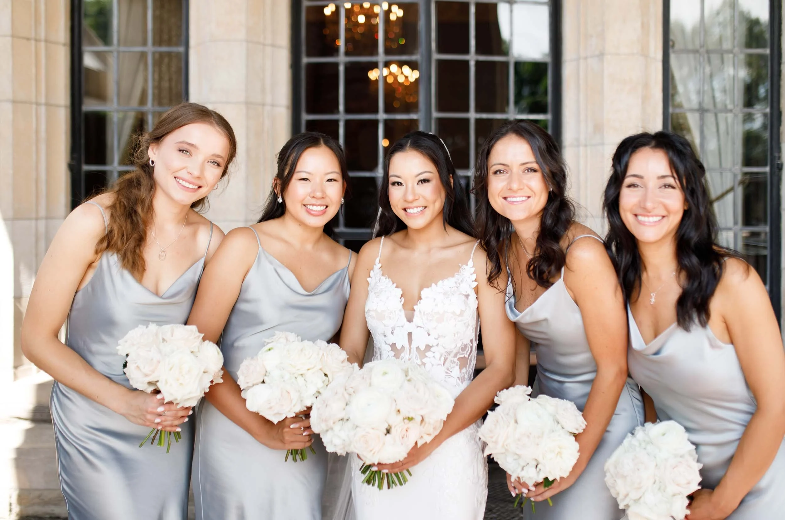 Bride and bridesmaids smiling at Casa Loma