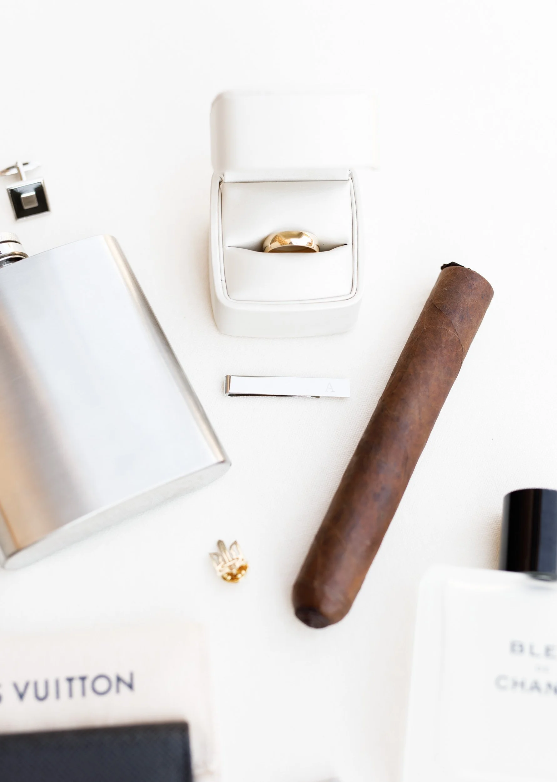 Wedding day flat lay with cologne and cigar at St. George’s Golf Club in Toronto
