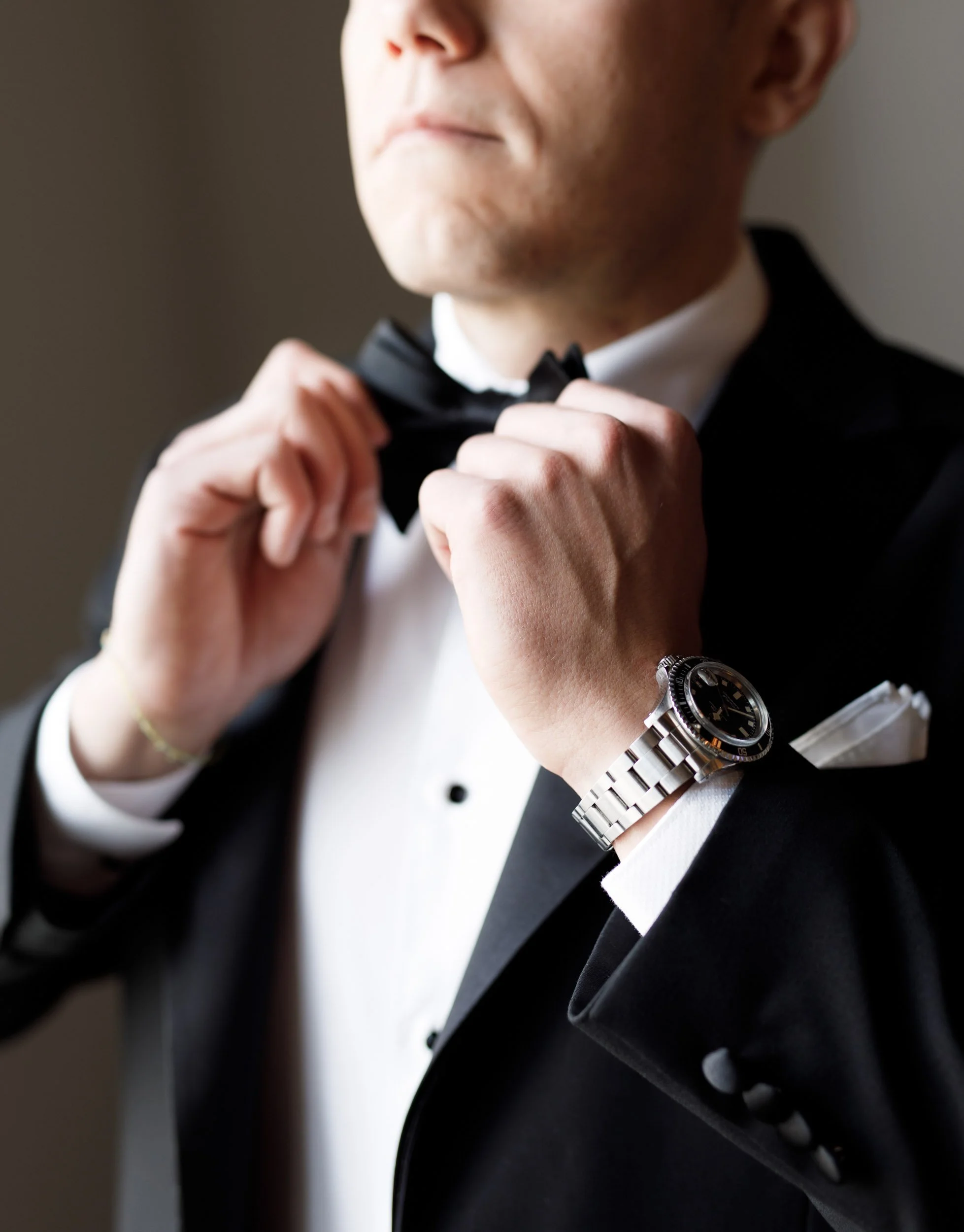 Groom adjusting his bow tie at a St. George’s Golf Club wedding in Toronto