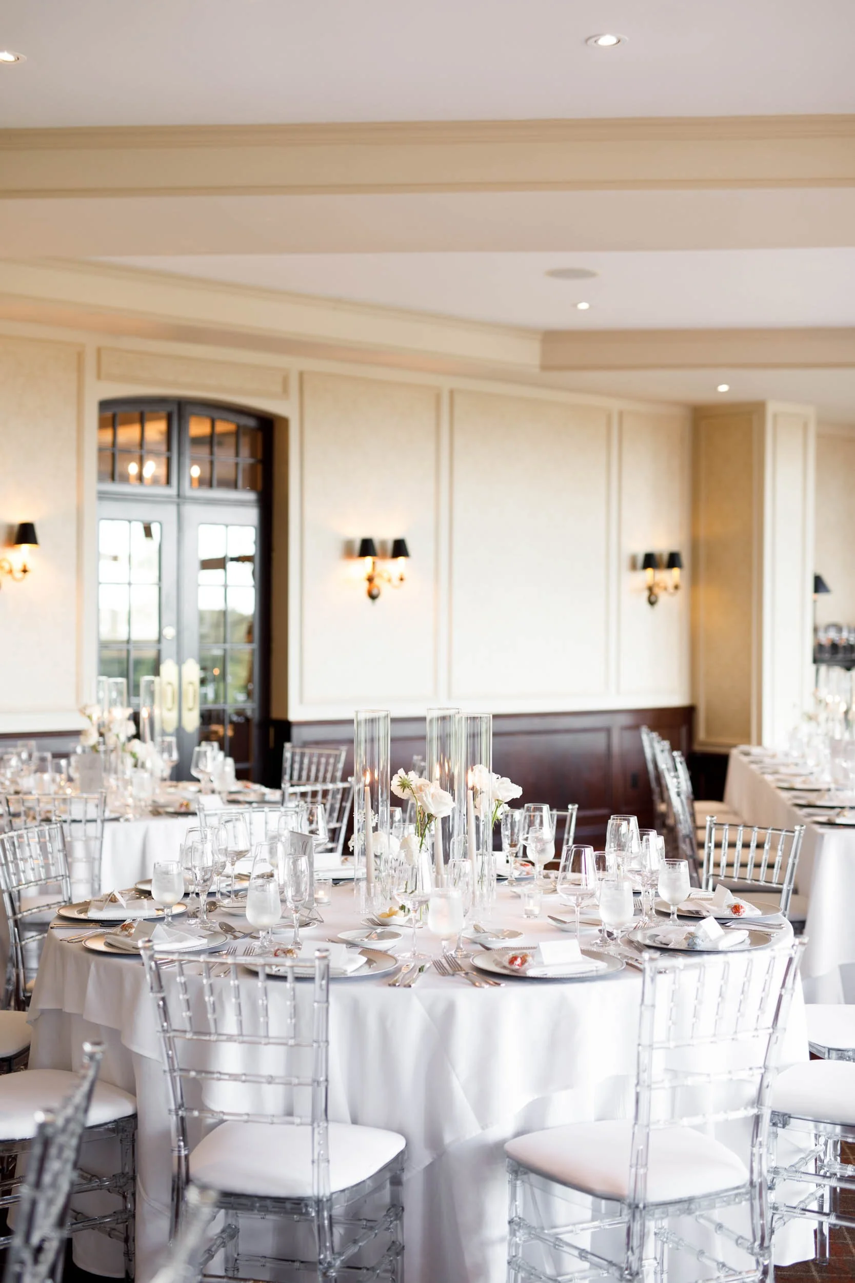 Wedding tables arranged by the windows at St. George’s Golf Club in Toronto
