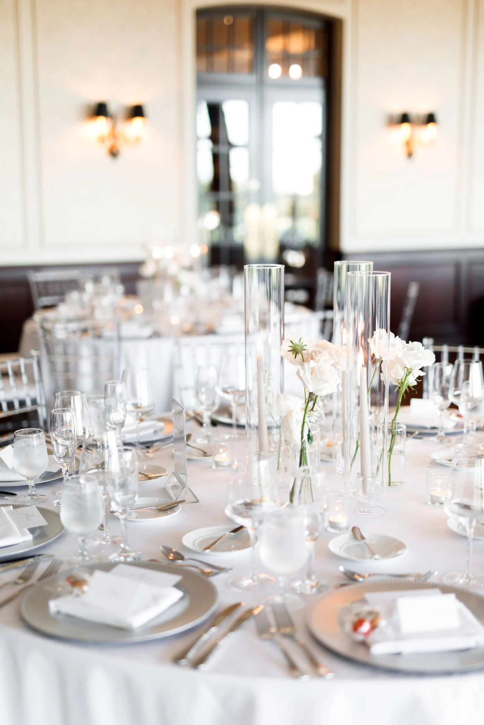 Wedding reception table with white linens and glassware at St. George’s Golf and Country Club in Toronto