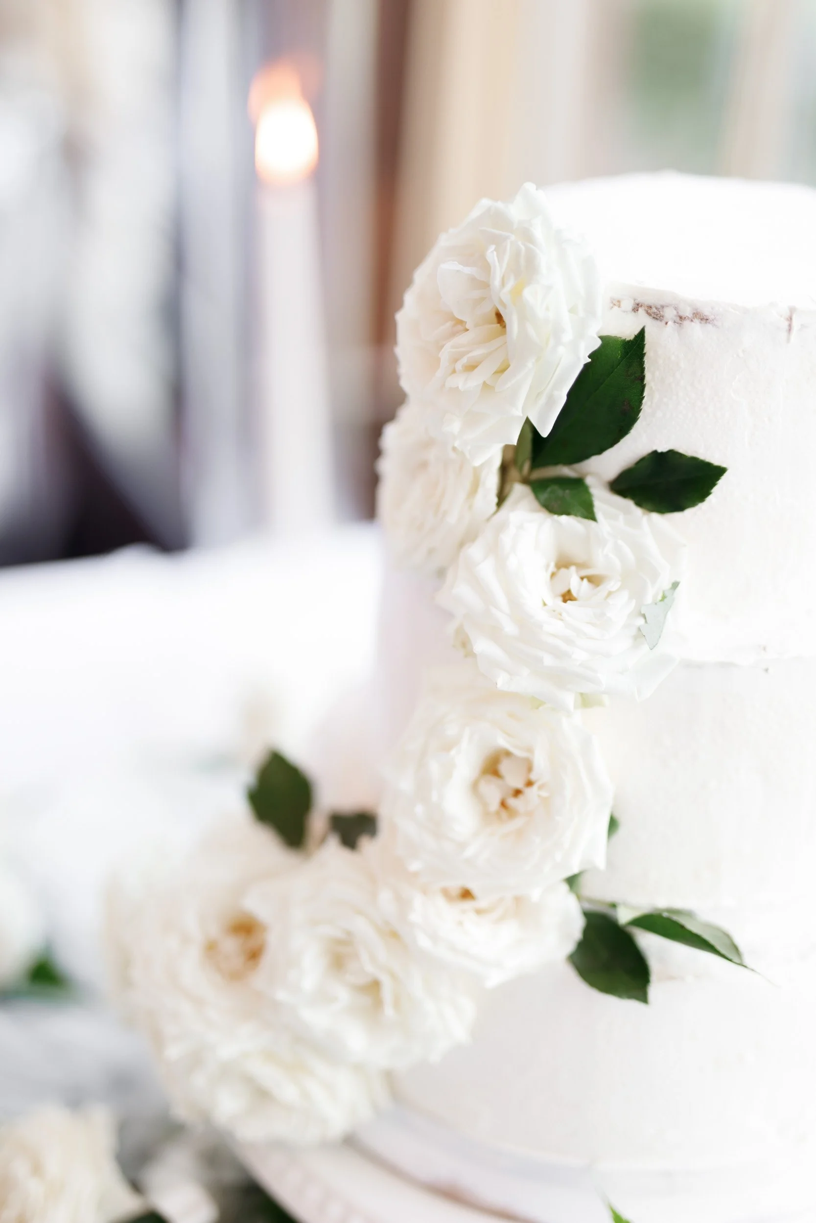 Close-up of the wedding cake decorated with white flowers at St. George’s Golf Club in Toronto