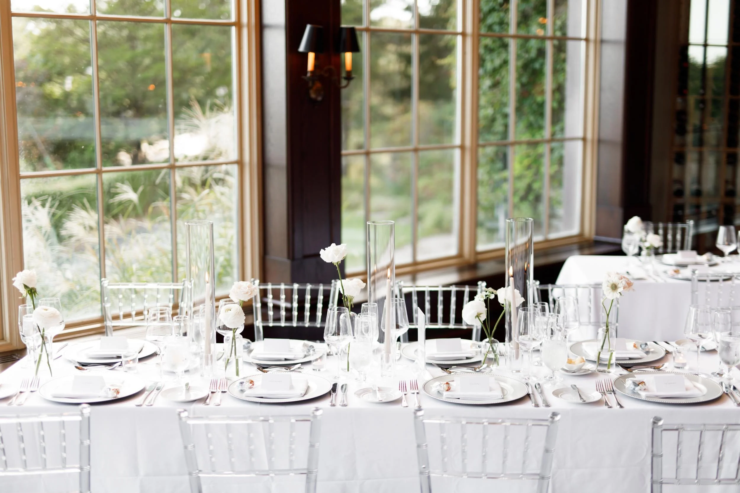 Window-side wedding tables set for a reception at St. George’s Golf and Country Club in Toronto