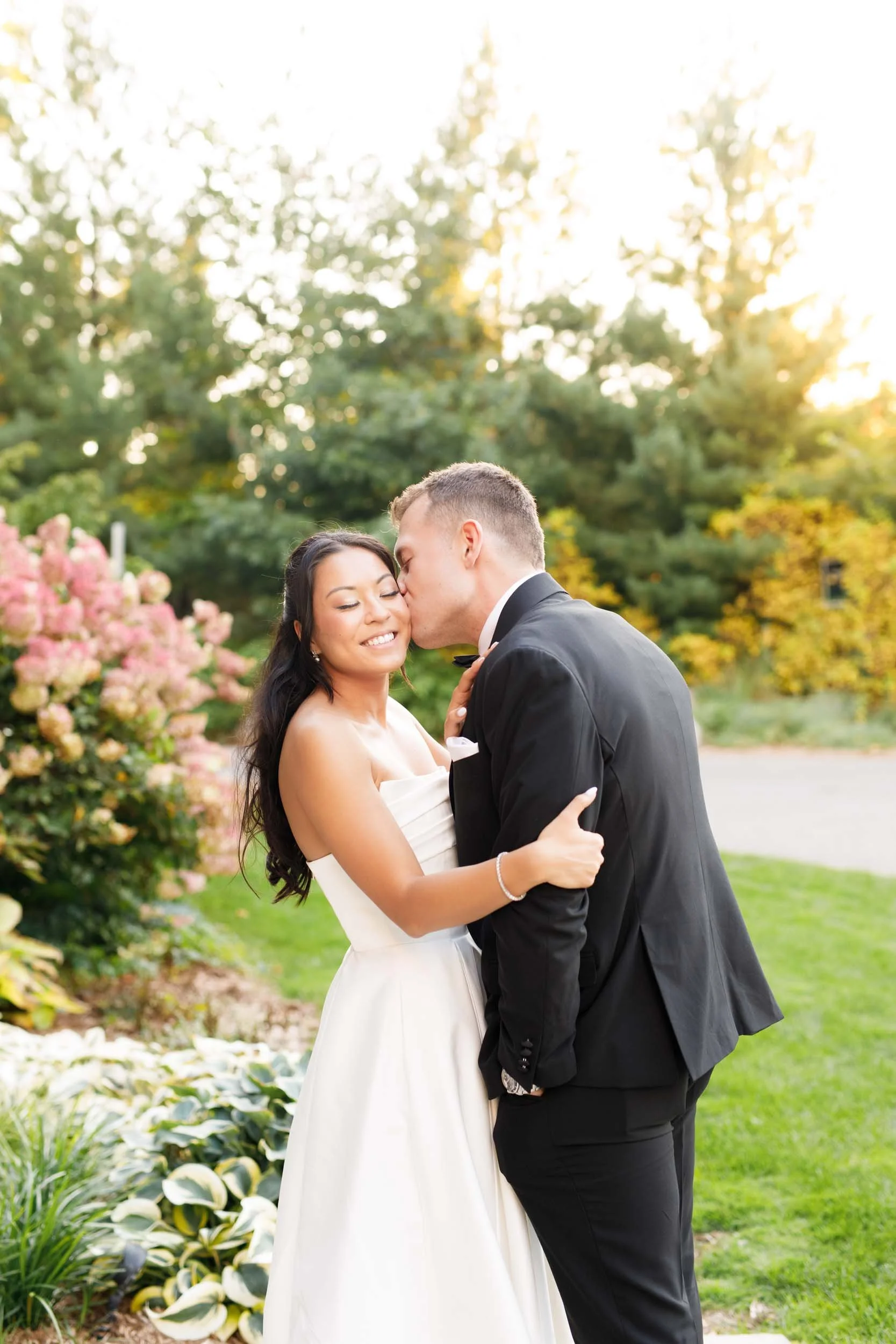 Bride and groom embracing on the lawn at St. George’s Golf and Country Club in Toronto during their wedding