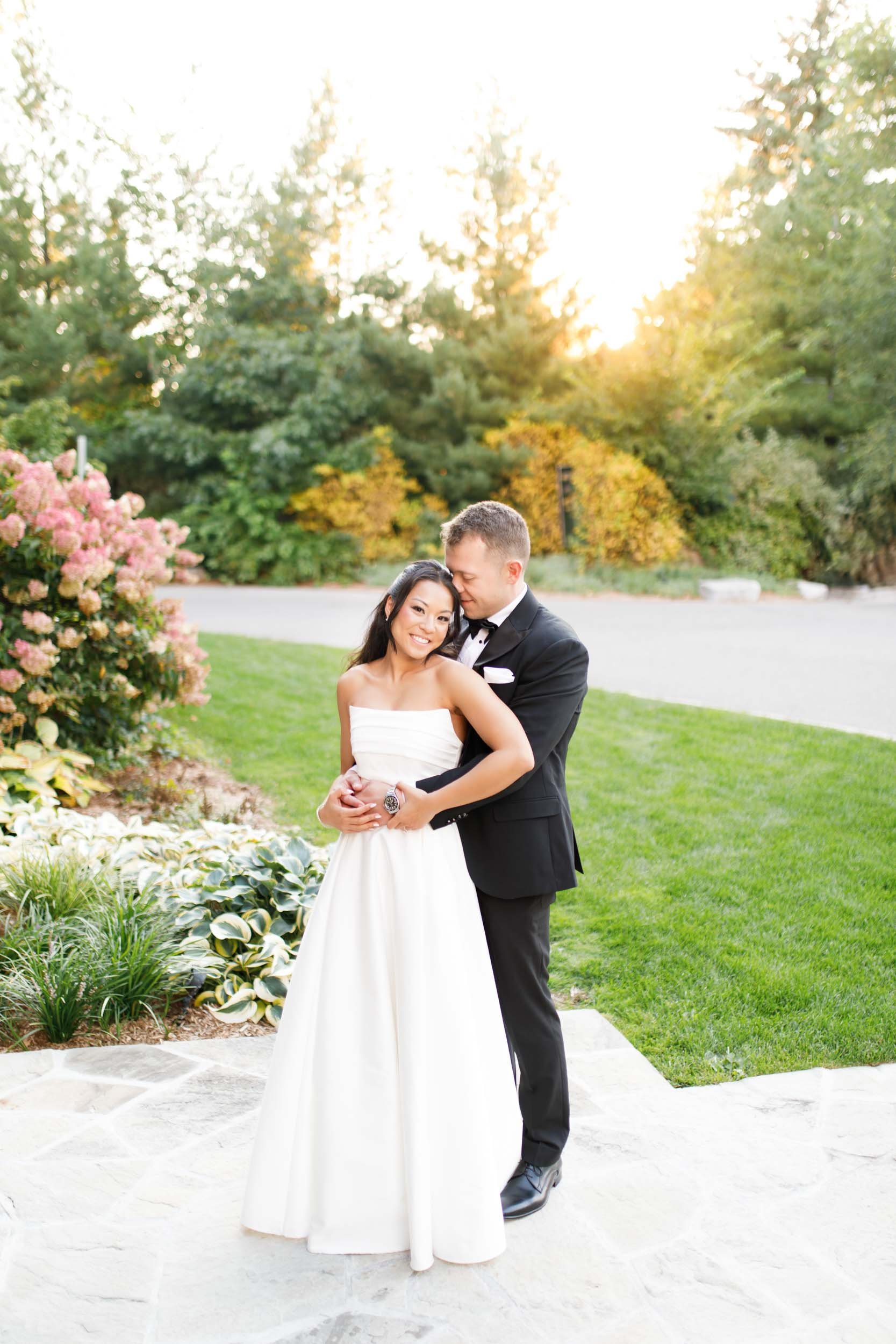 Bride leaning into the groom during their St. George’s Golf Club wedding in Toronto