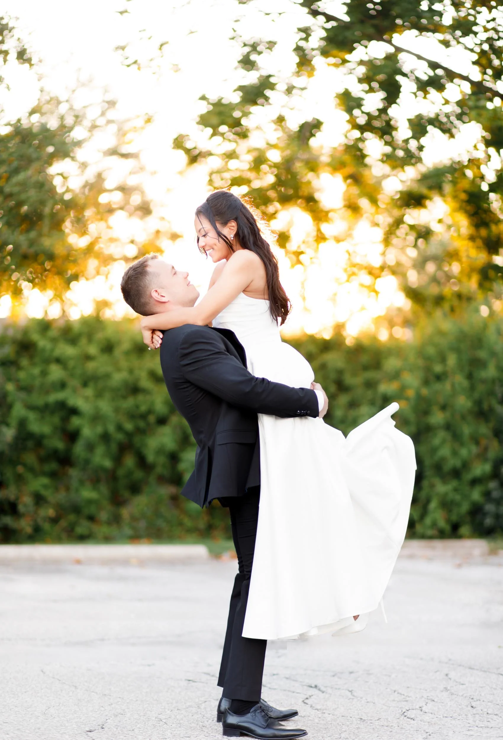 Groom lifting the bride during sunset at St. George’s Golf and Country Club in Toronto
