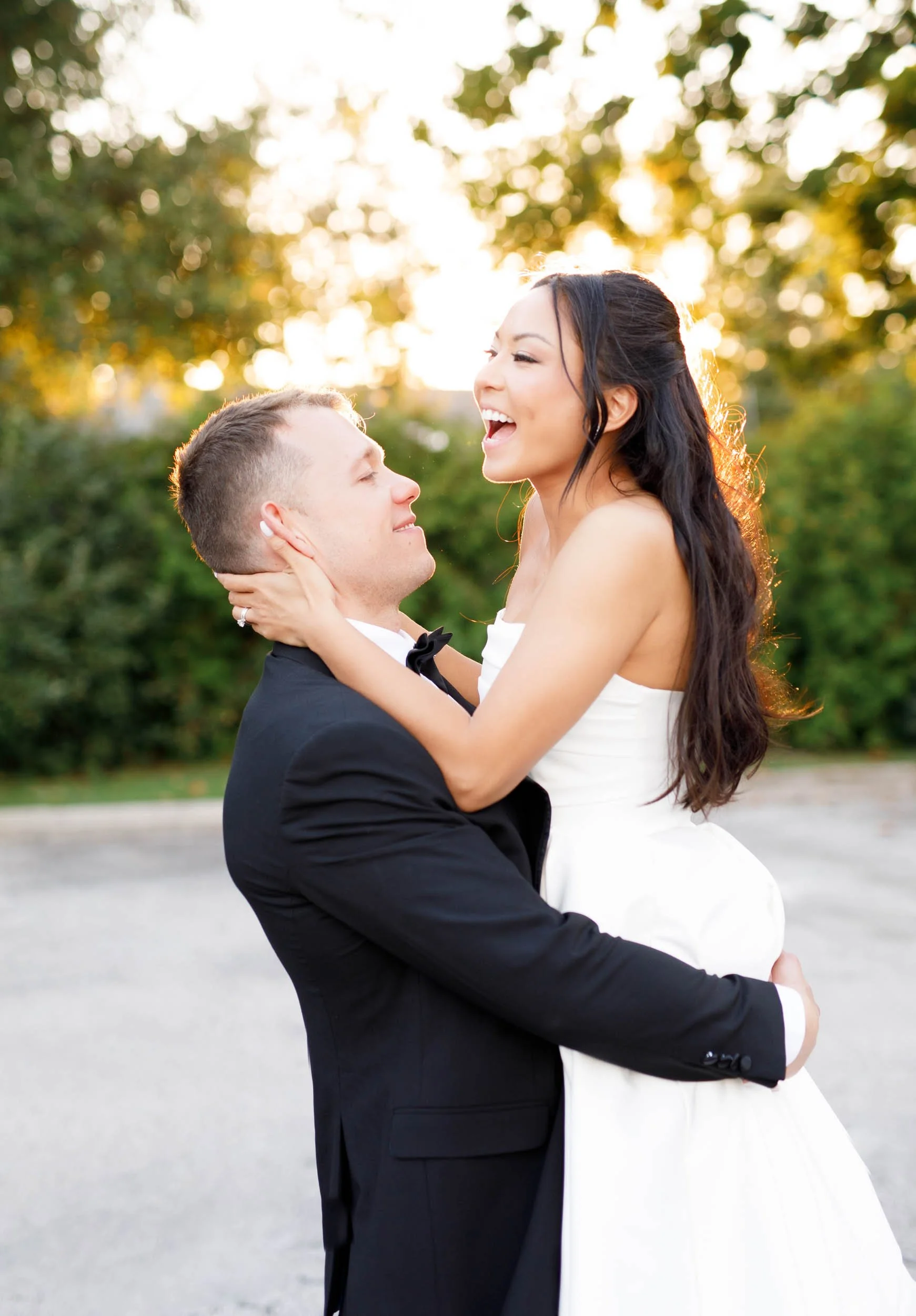 Bride laughing while the groom holds her at St. George’s Golf and Country Club in Toronto