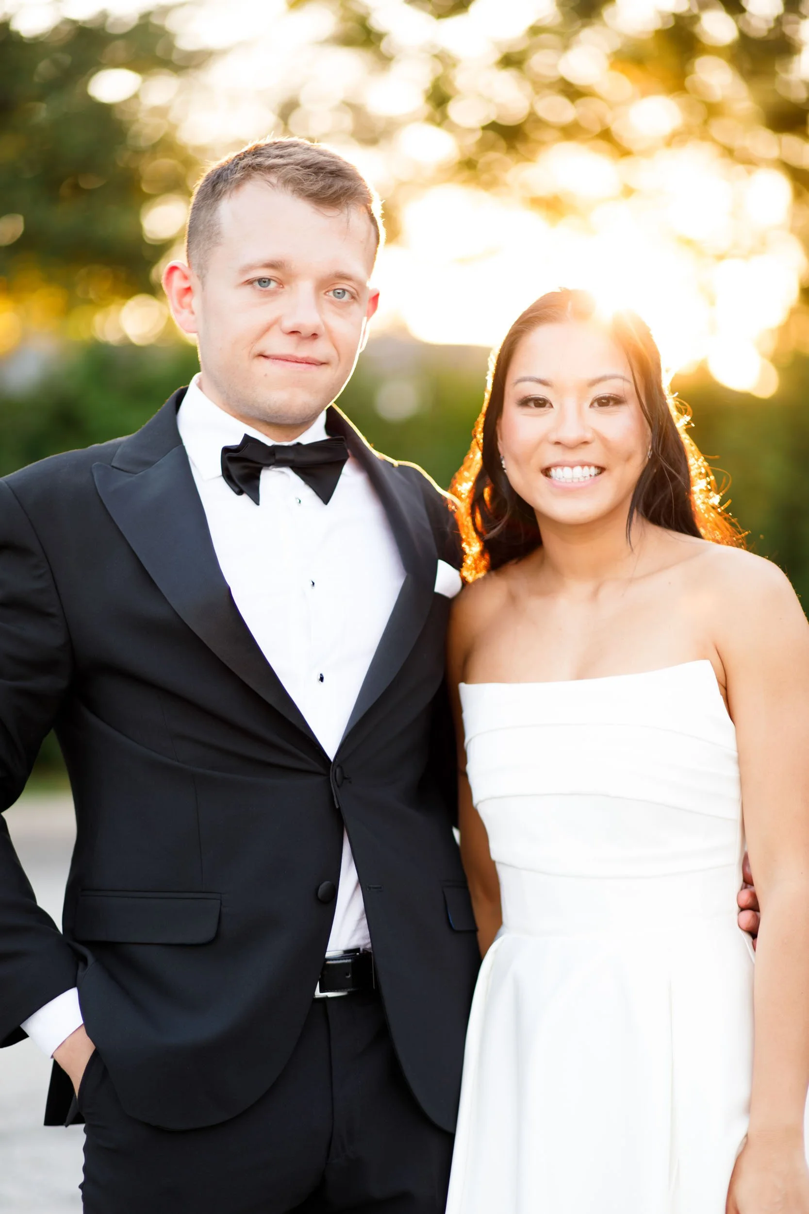 Bride and groom smiling together in sunset light at St. George’s Golf Club in Toronto