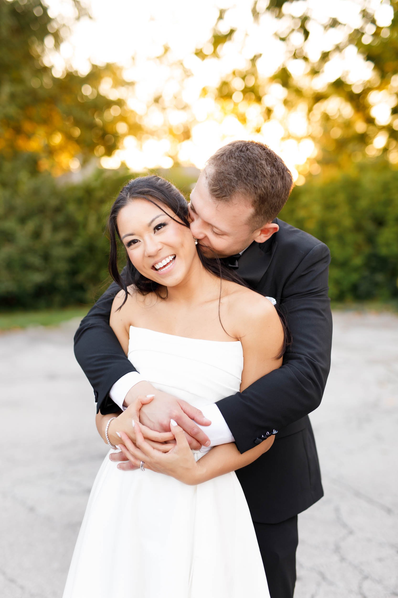 Groom hugging the bride from behind during a sunset wedding portrait at St. George’s Golf and Country Club in Toronto