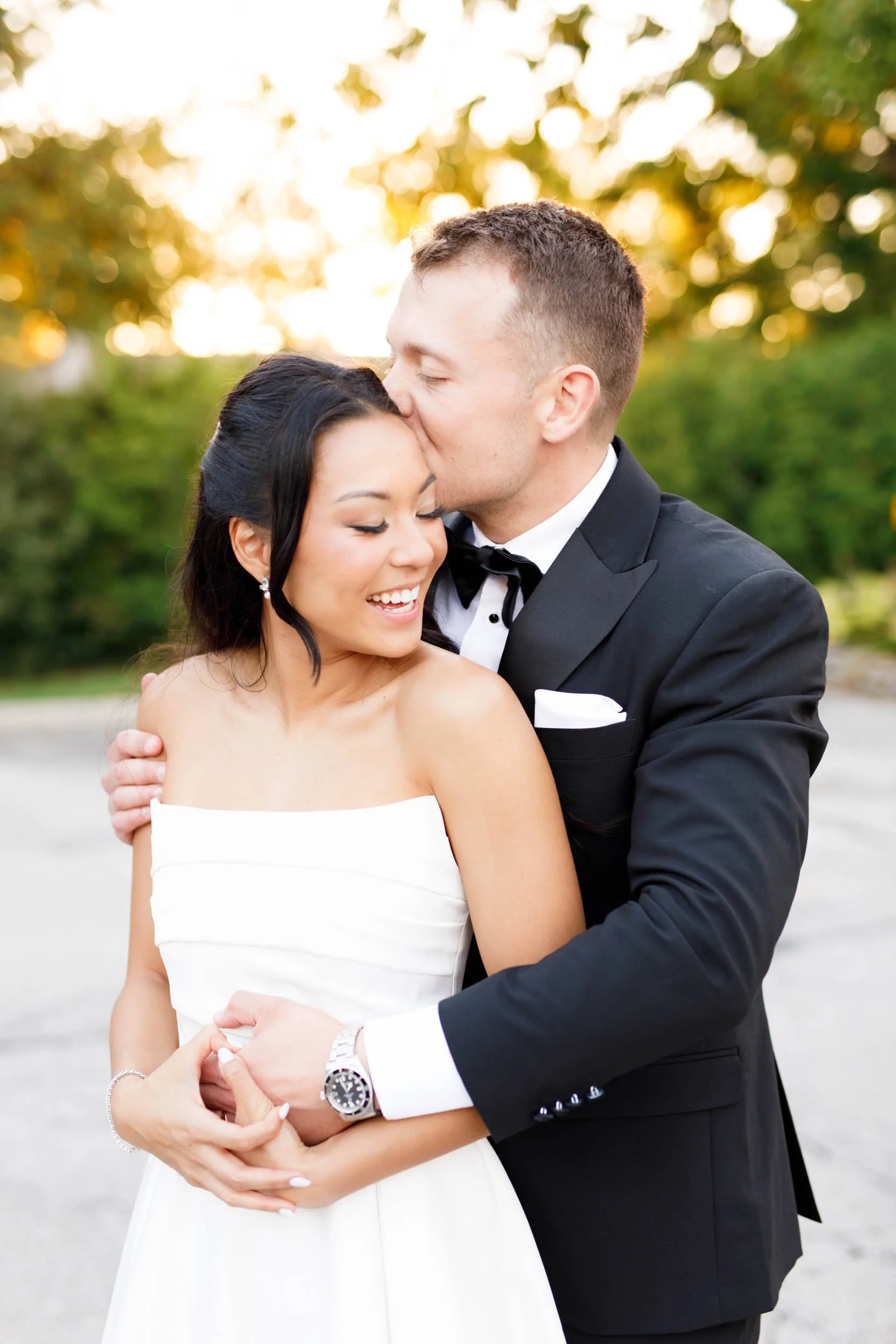 Groom kissing the bride’s head during a St. George’s Golf Club wedding in Toronto