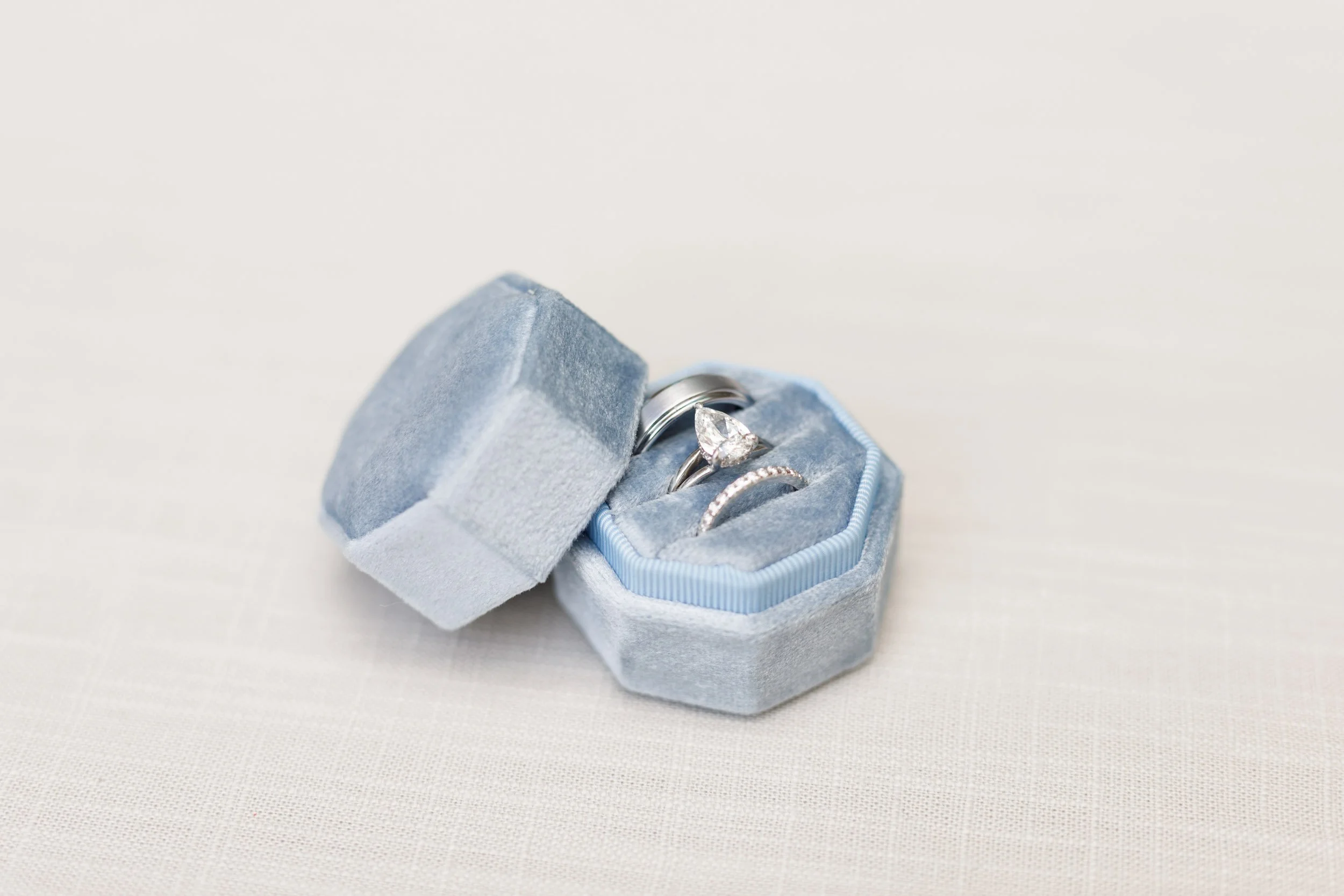 Engagement rings in blue velvet boxes from a Pearle Hotel wedding in Burlington Ontario