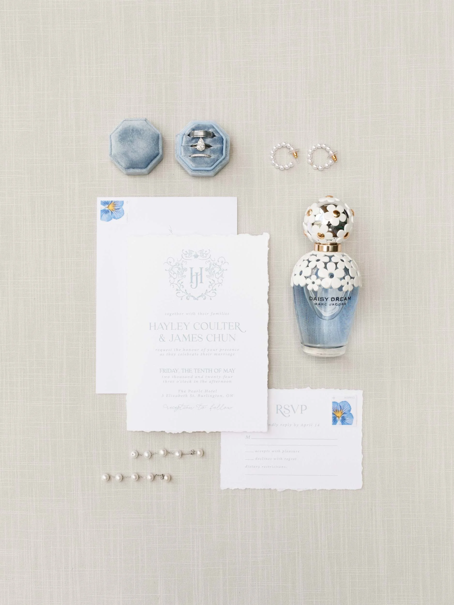 Wedding invitation flat lay with rings and stationery from a Pearle Hotel wedding in Burlington Ontario