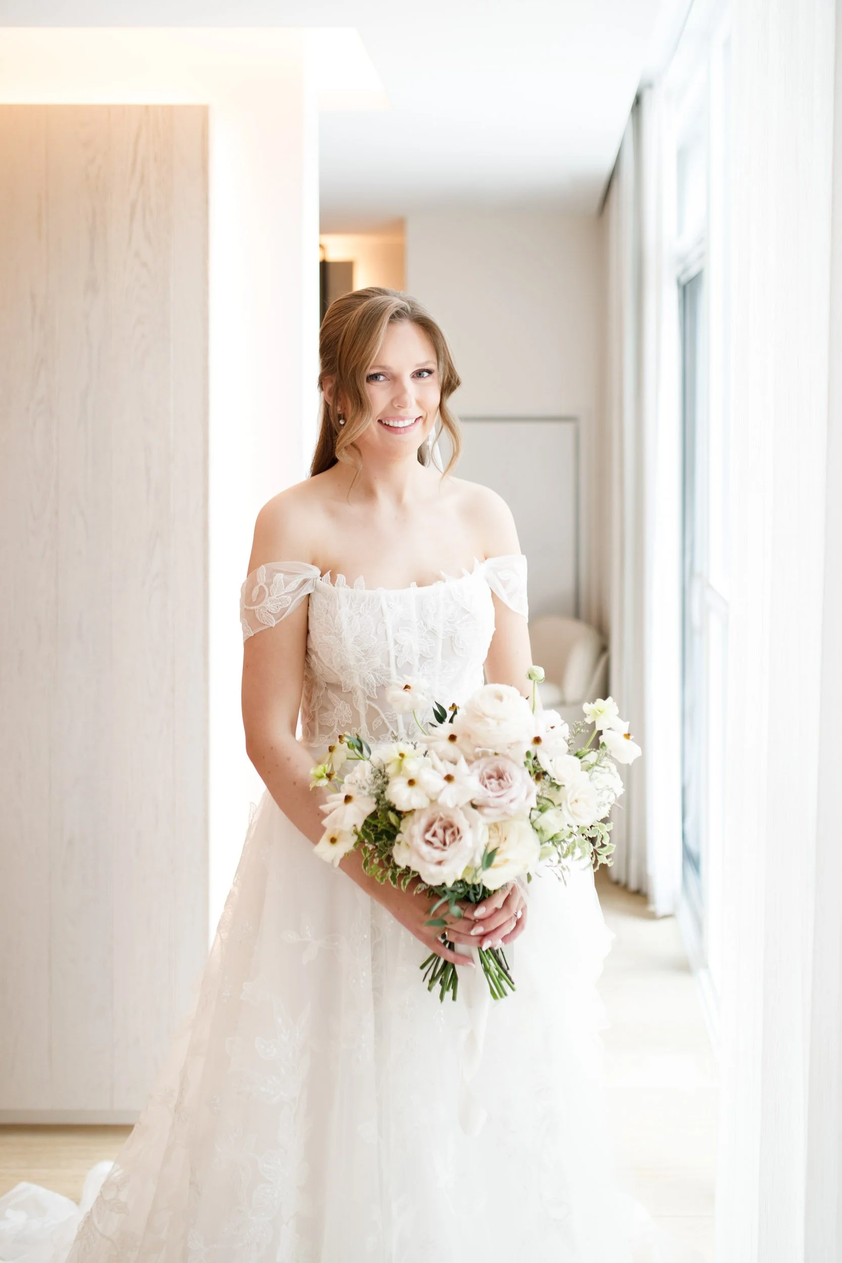Bride holding her bouquet in a bright hotel suite at the Pearle Hotel in Burlington Ontario