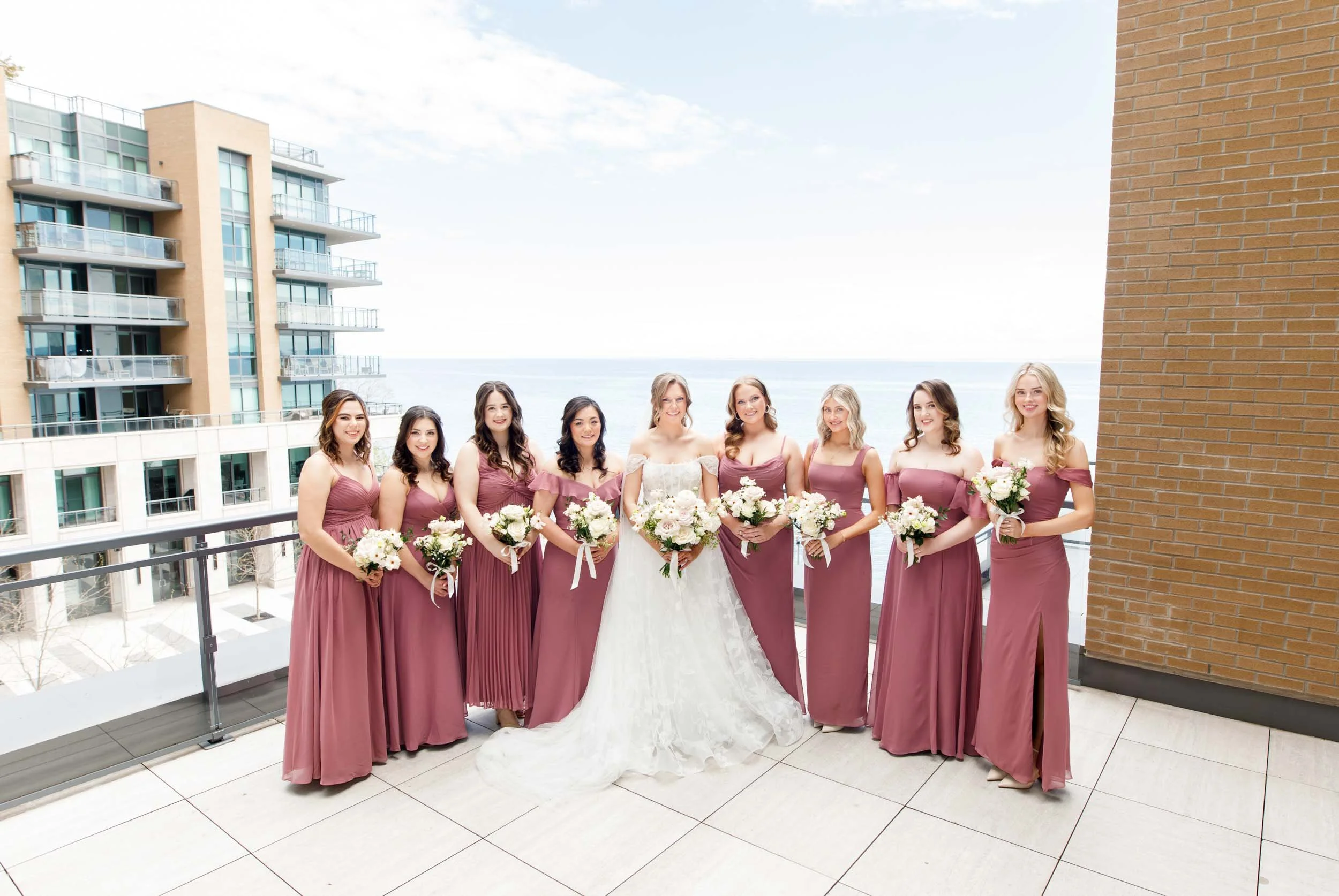 Bridesmaids and bride on the waterfront terrace at the Pearle Hotel in Burlington Ontario