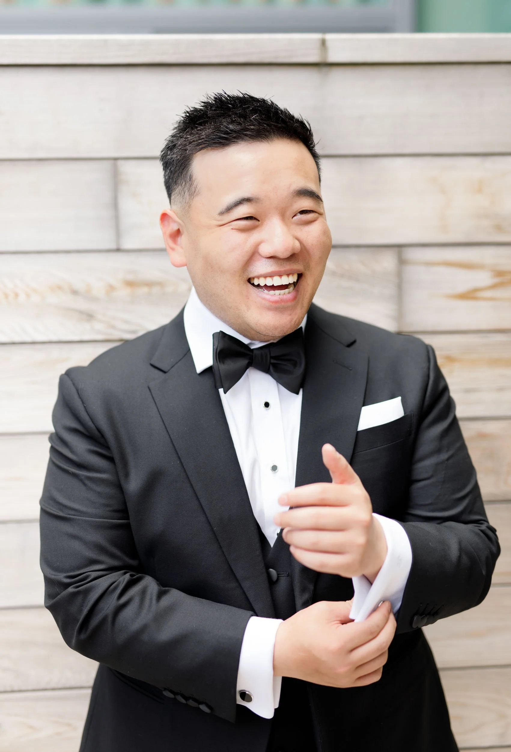 Groom laughing in his tuxedo during a Pearle Hotel wedding in Burlington Ontario