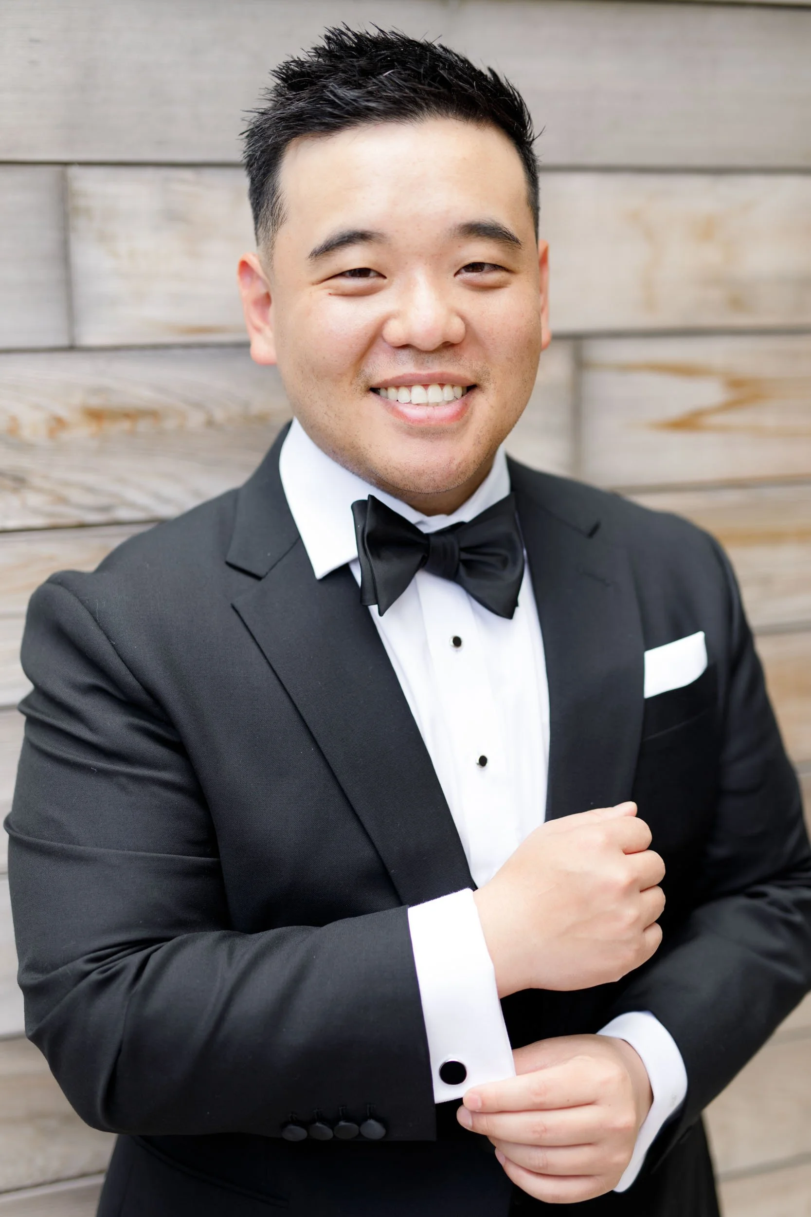 Portrait of the groom in a black tuxedo at the Pearle Hotel in Burlington Ontario