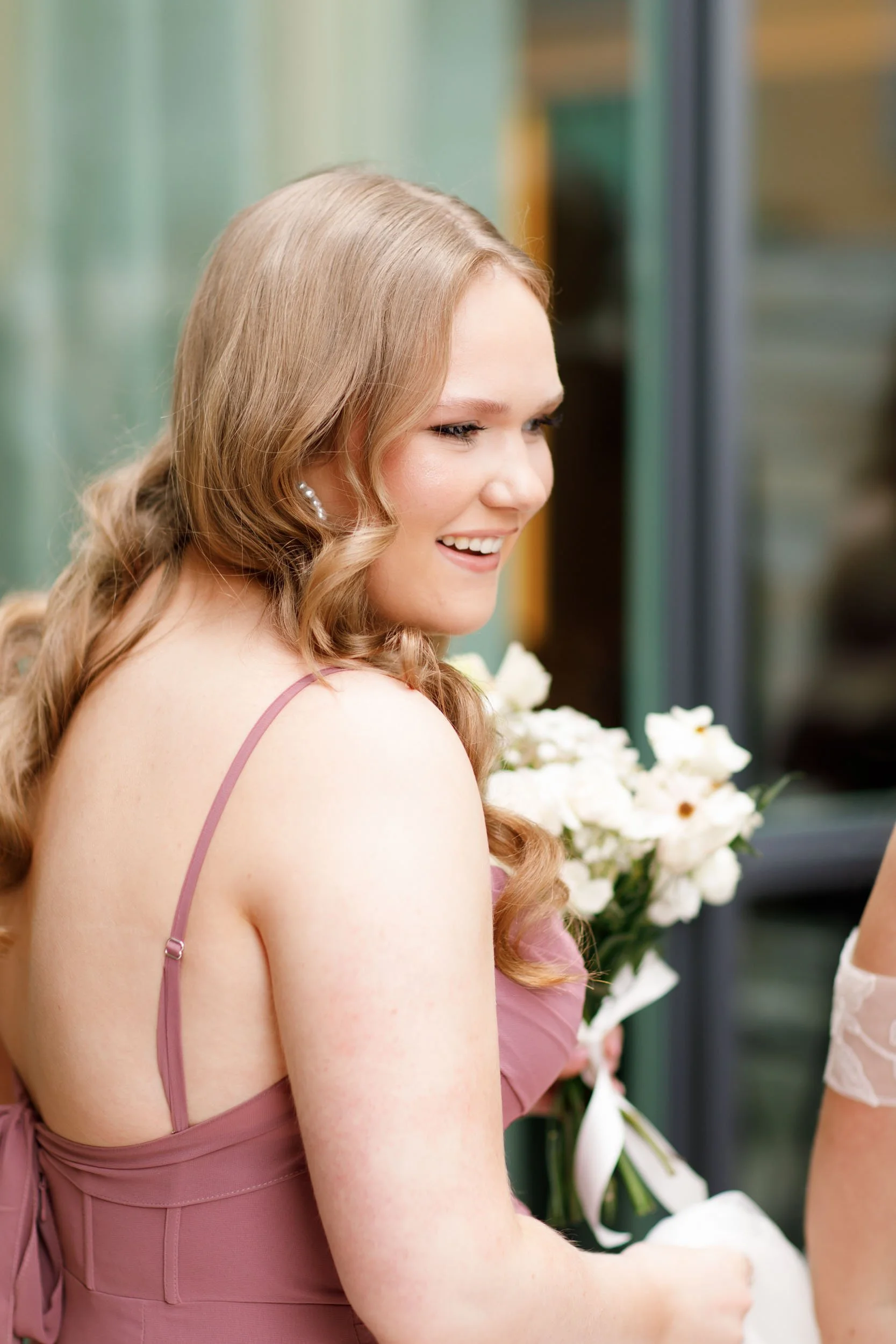 Bridesmaid holding a bouquet during a Pearle Hotel wedding in Burlington Ontario