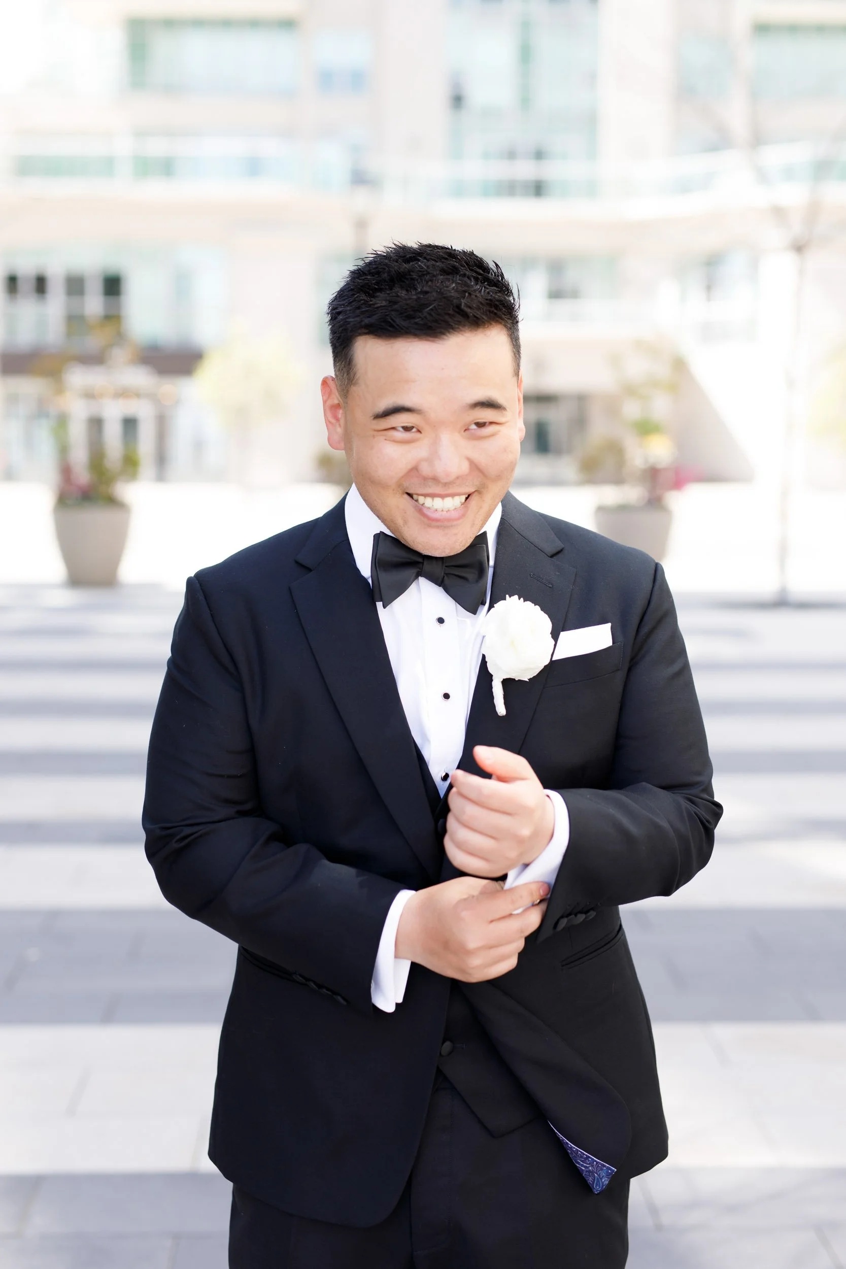 Portrait of the groom smiling in his tuxedo at the Pearle Hotel in Burlington Ontario