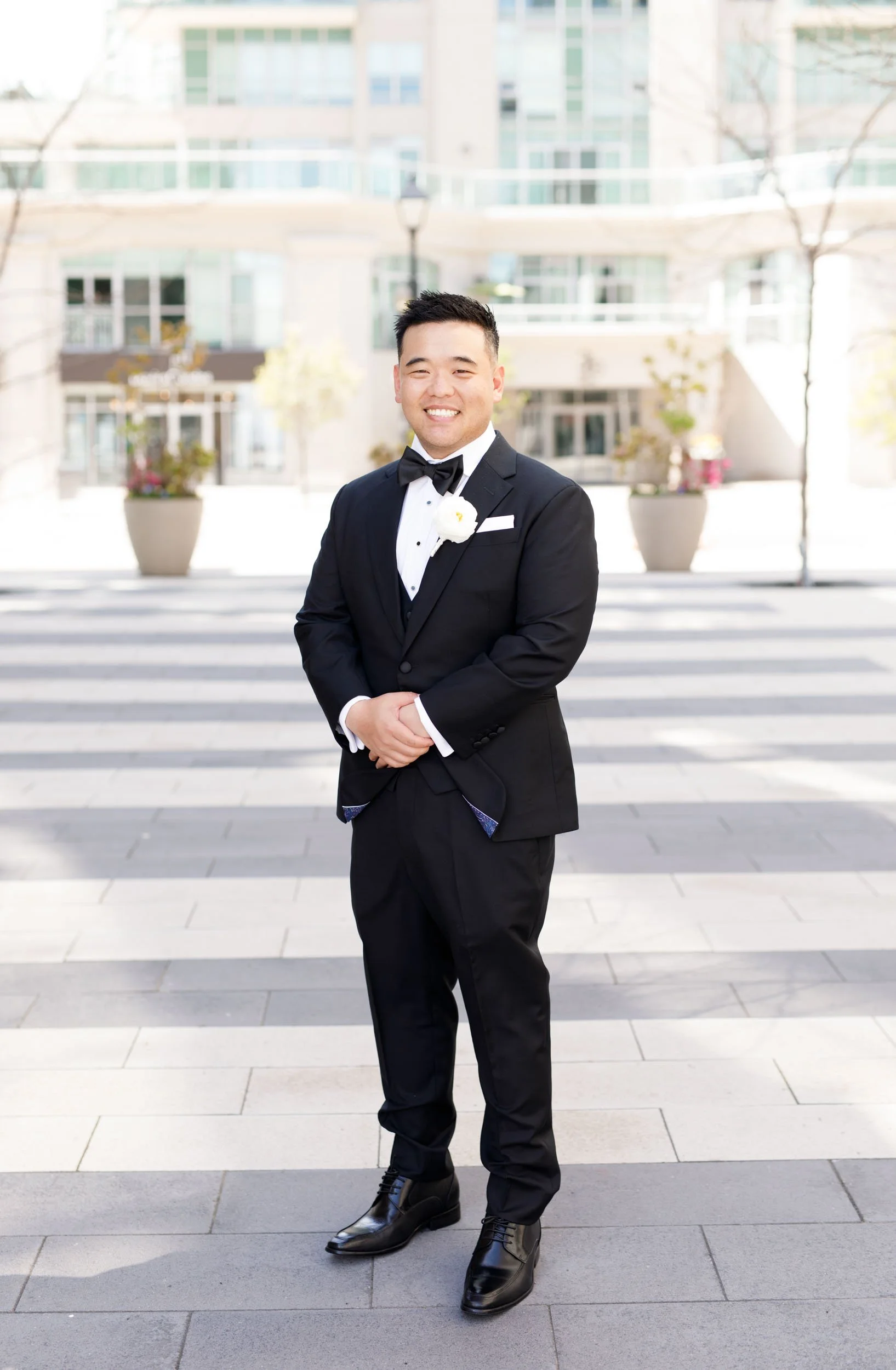 Groom standing outside the Pearle Hotel in Burlington Ontario