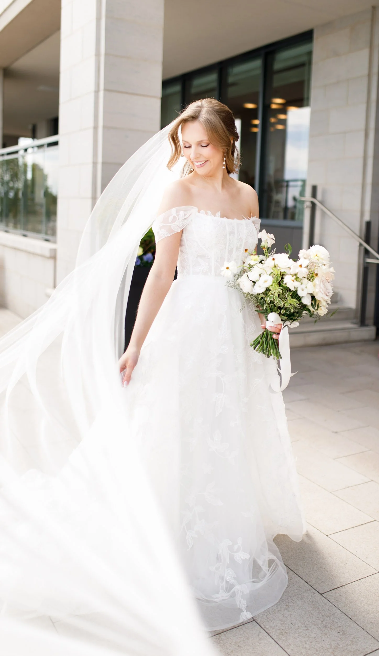 Bride walking with her veil flowing at the Pearle Hotel in Burlington Ontario