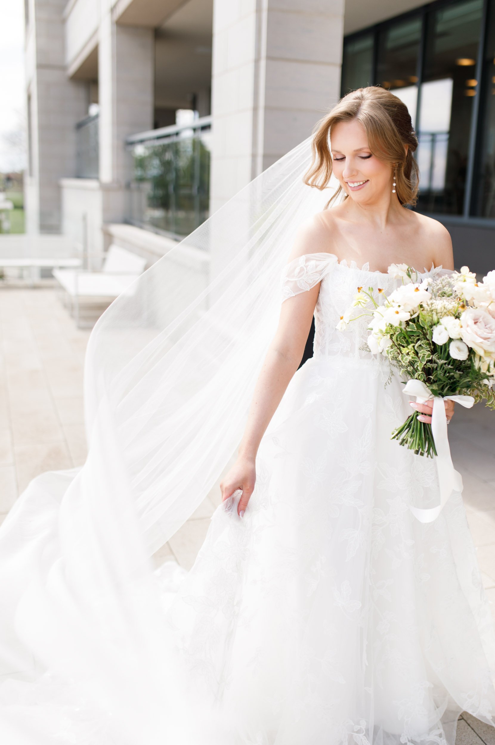 Bride smiling with her bouquet at the Pearle Hotel in Burlington Ontario