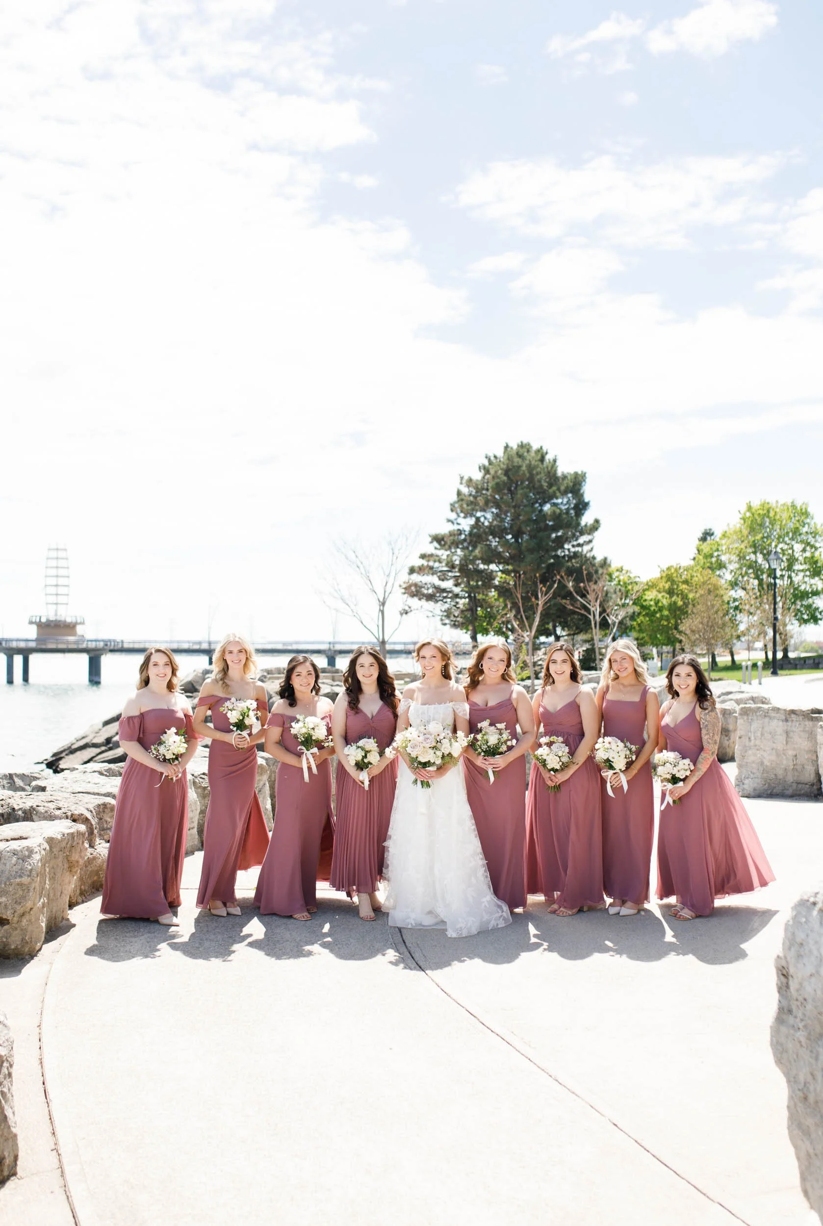 Bridesmaids standing together on the waterfront at the Pearle Hotel in Burlington Ontario