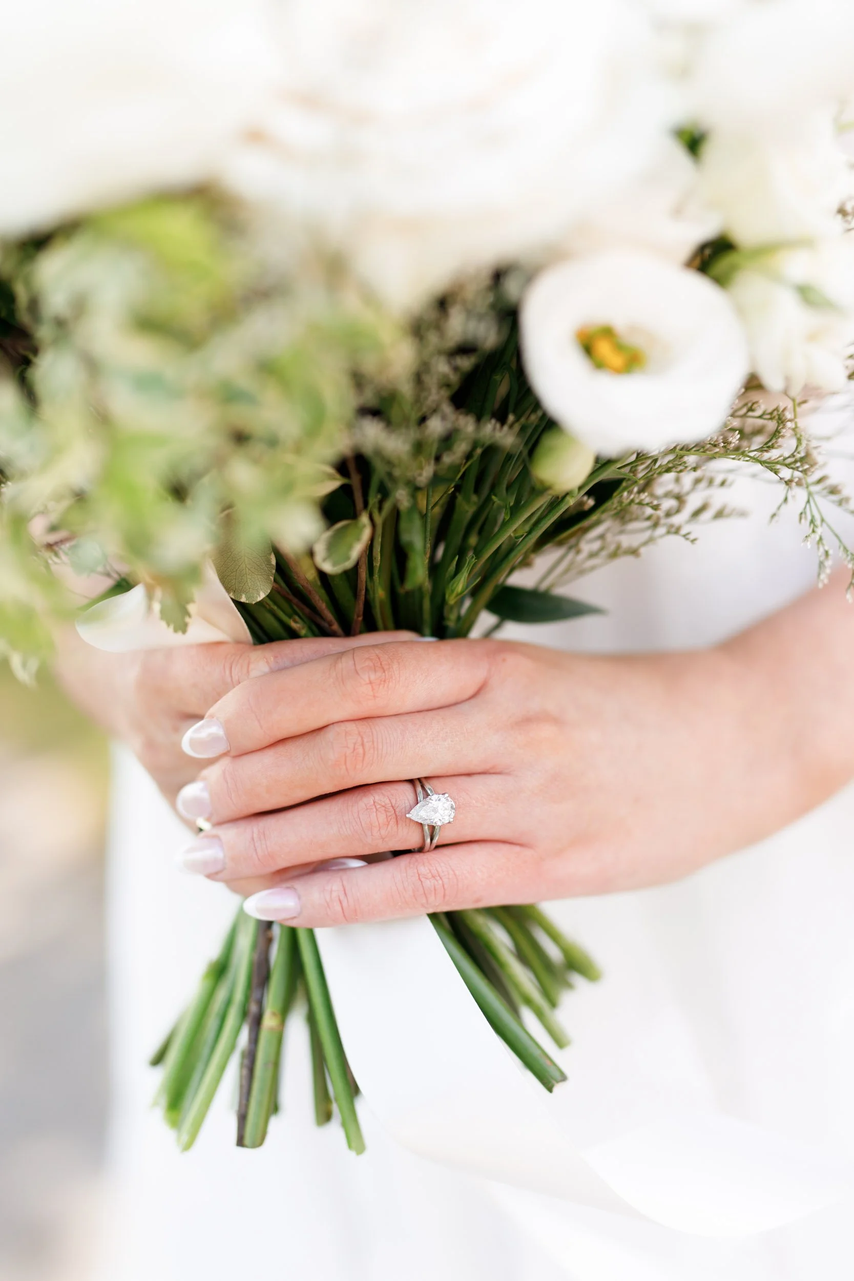 Bride holding her bouquet showing her engagement ring at the Pearle Hotel in Burlington Ontario