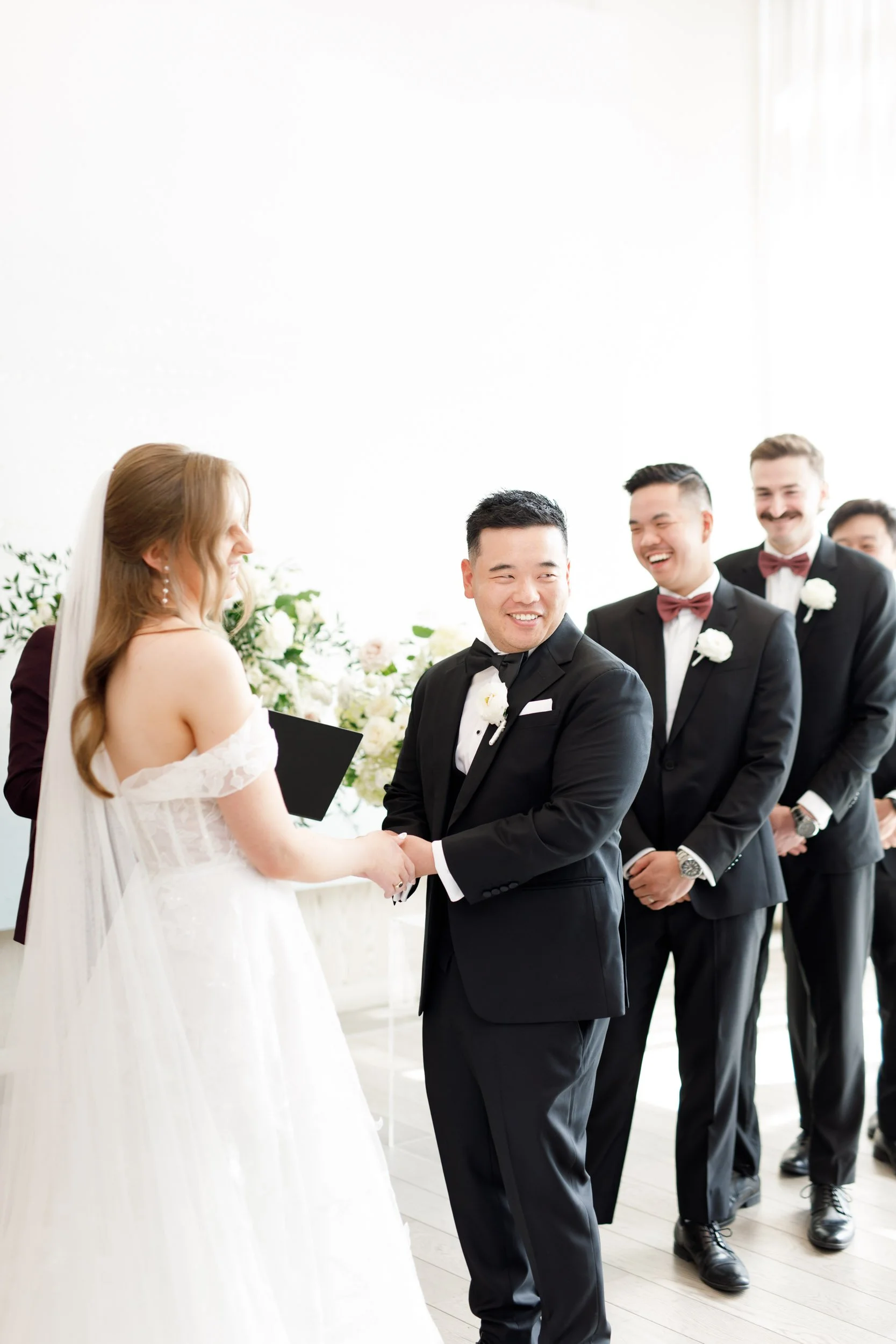 Bride and groom standing together with their wedding party at the Pearle Hotel in Burlington Ontario