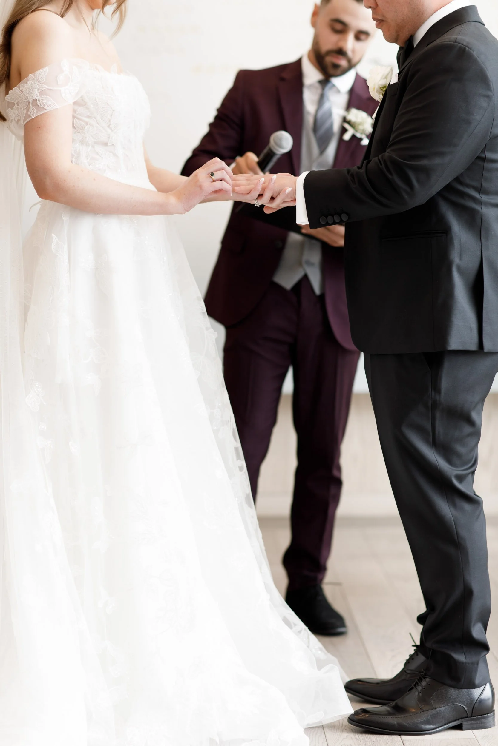 Close up of the bride and groom exchanging rings at the Pearle Hotel in Burlington Ontario