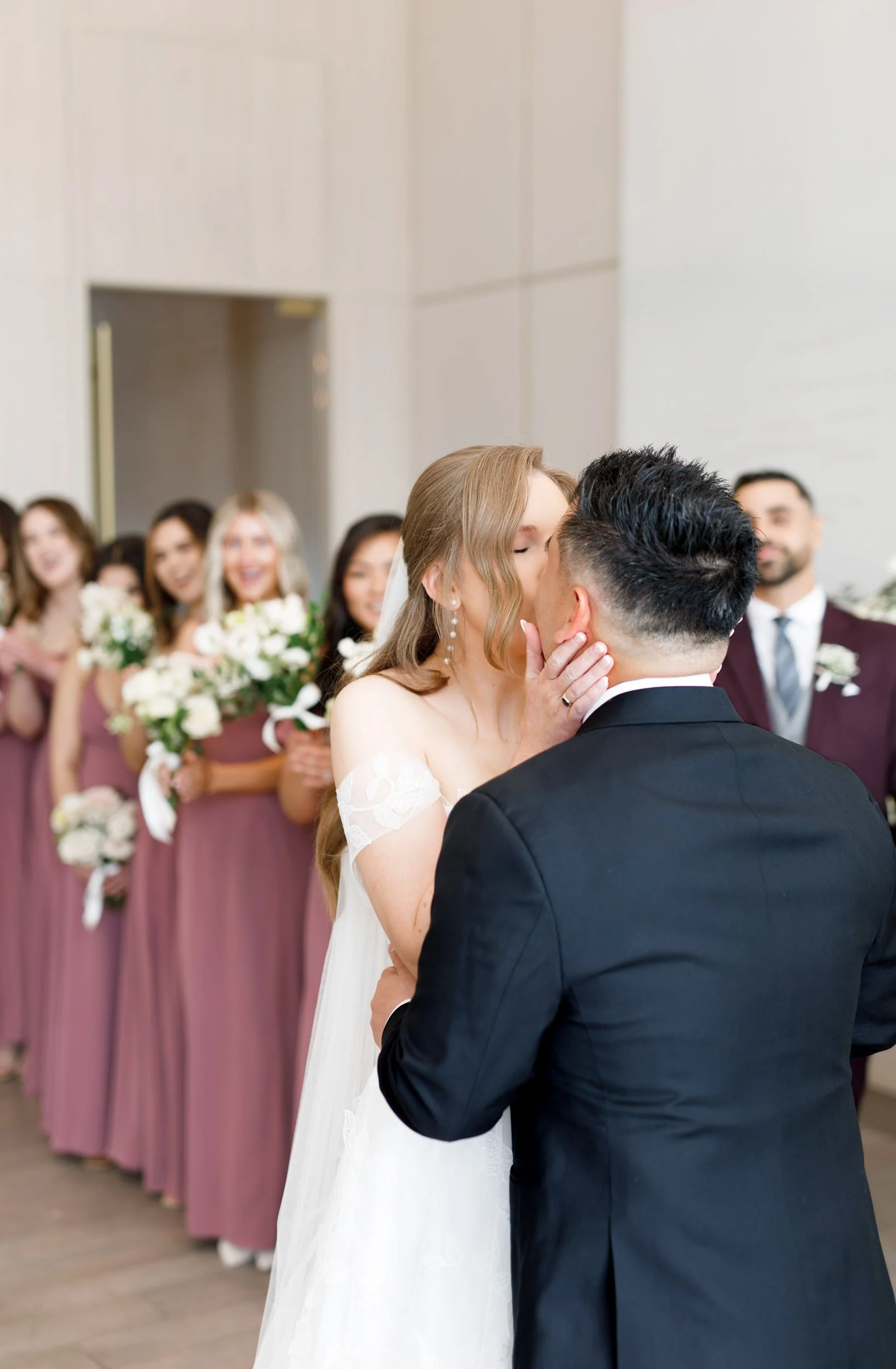 Bride and groom sharing a kiss during their Pearle Hotel wedding ceremony in Burlington Ontario