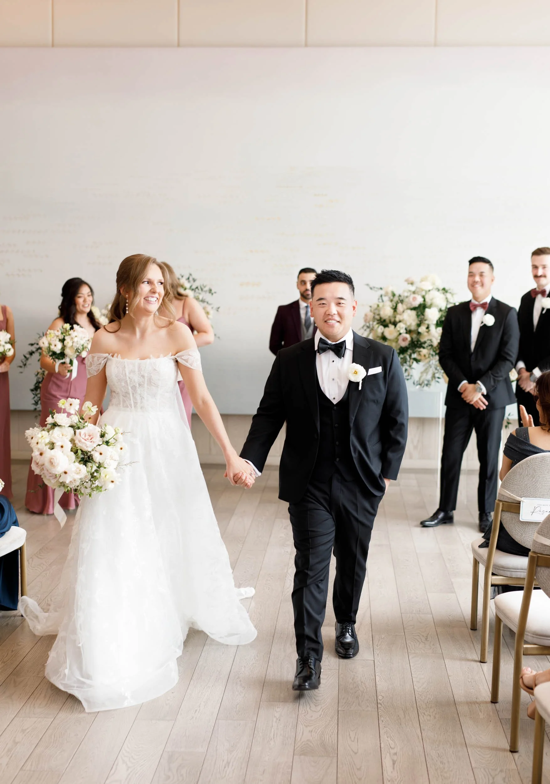 Bride and groom walking down the aisle after their Pearle Hotel ceremony in Burlington Ontario