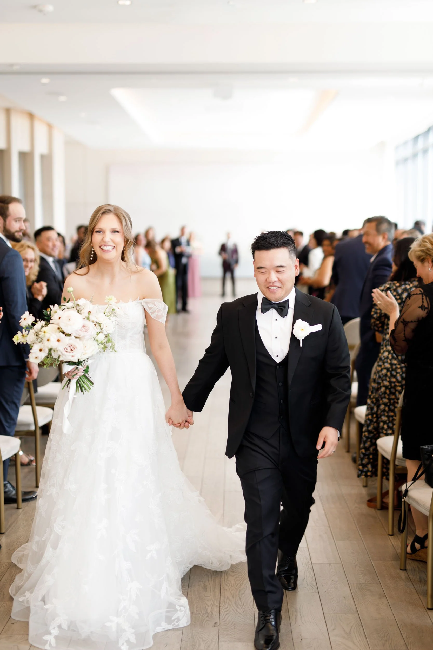 Bride and groom walking down the aisle after their Pearle Hotel wedding in Burlington Ontario