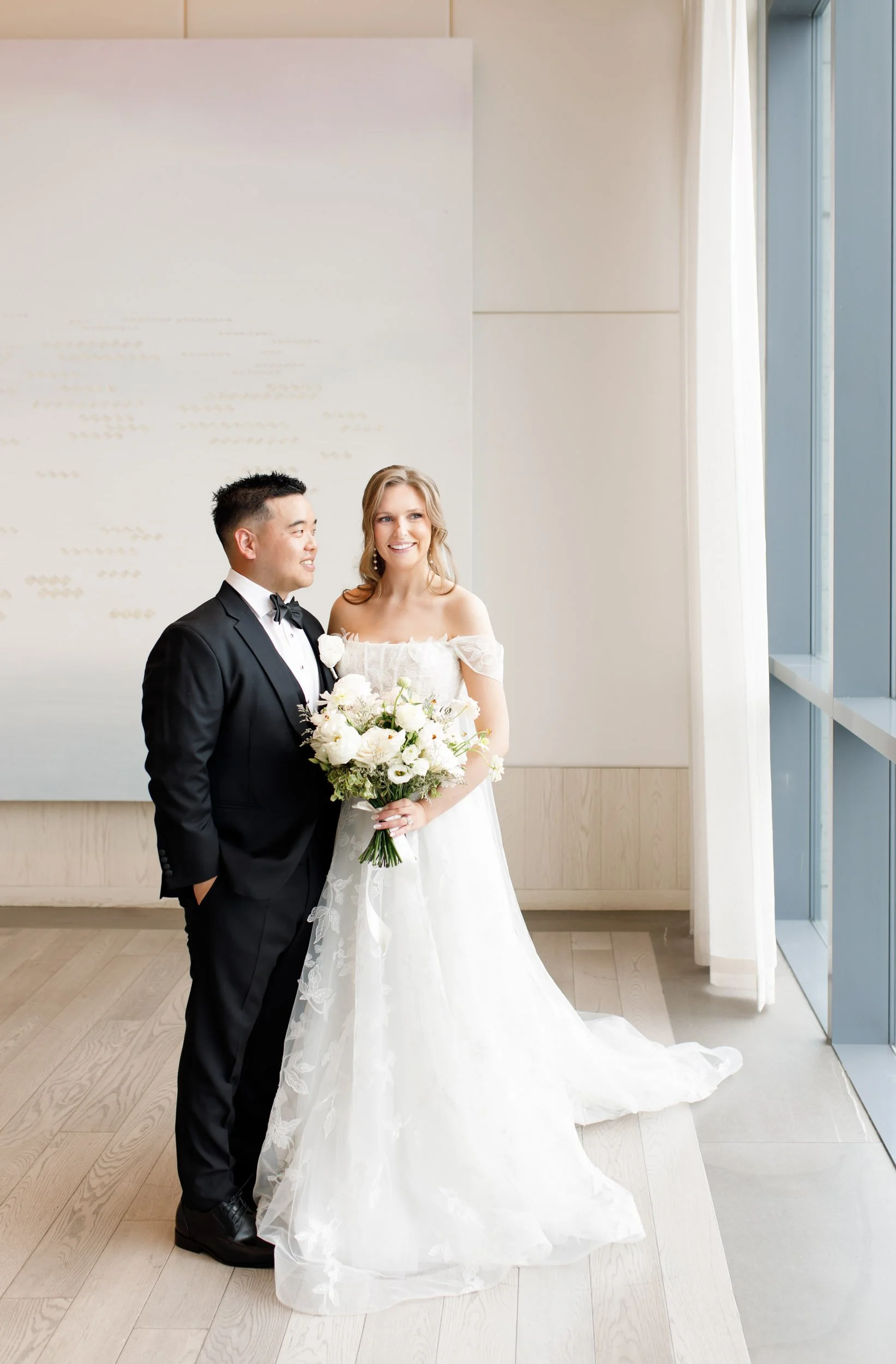 Bride and groom posing by the windows at the Pearle Hotel in Burlington Ontario