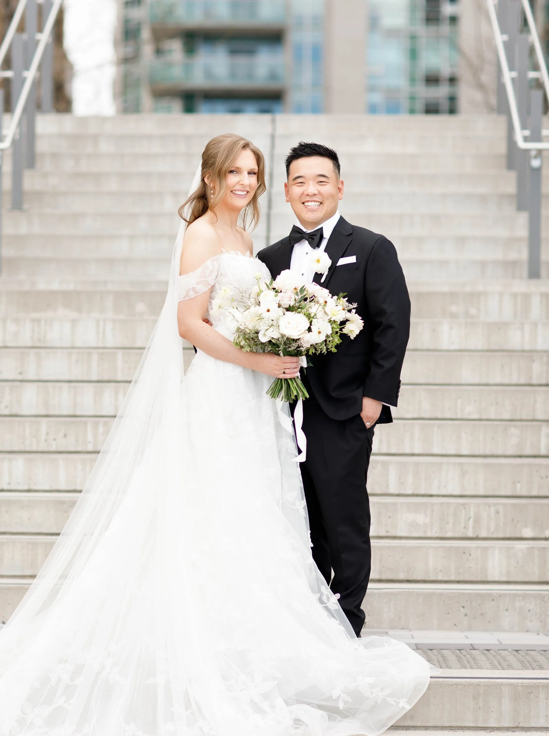 Bride and groom standing together on the Pearle Hotel staircase in Burlington Ontario