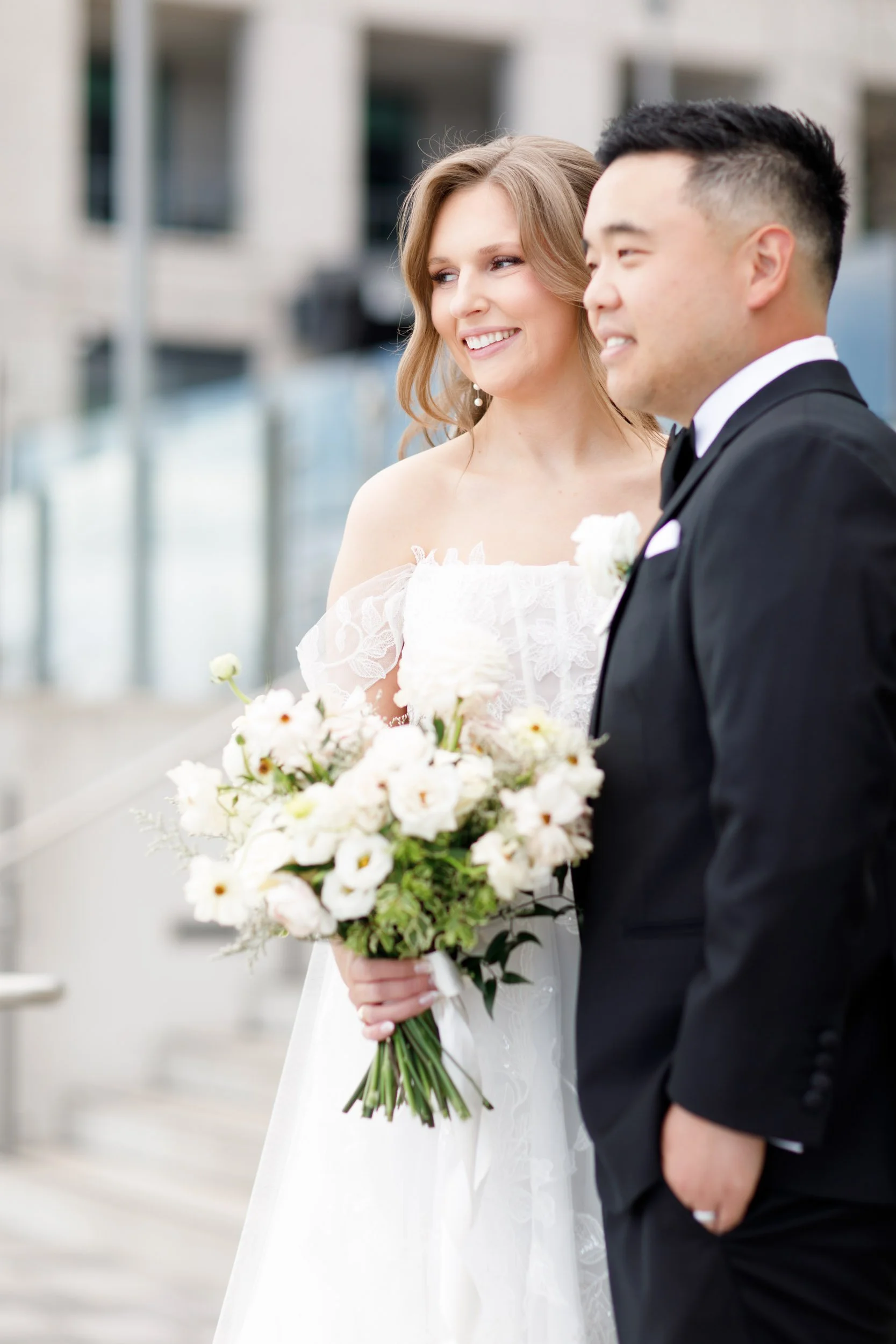 Bride and groom posing together in front of the Pearle Hotel in Burlington Ontario