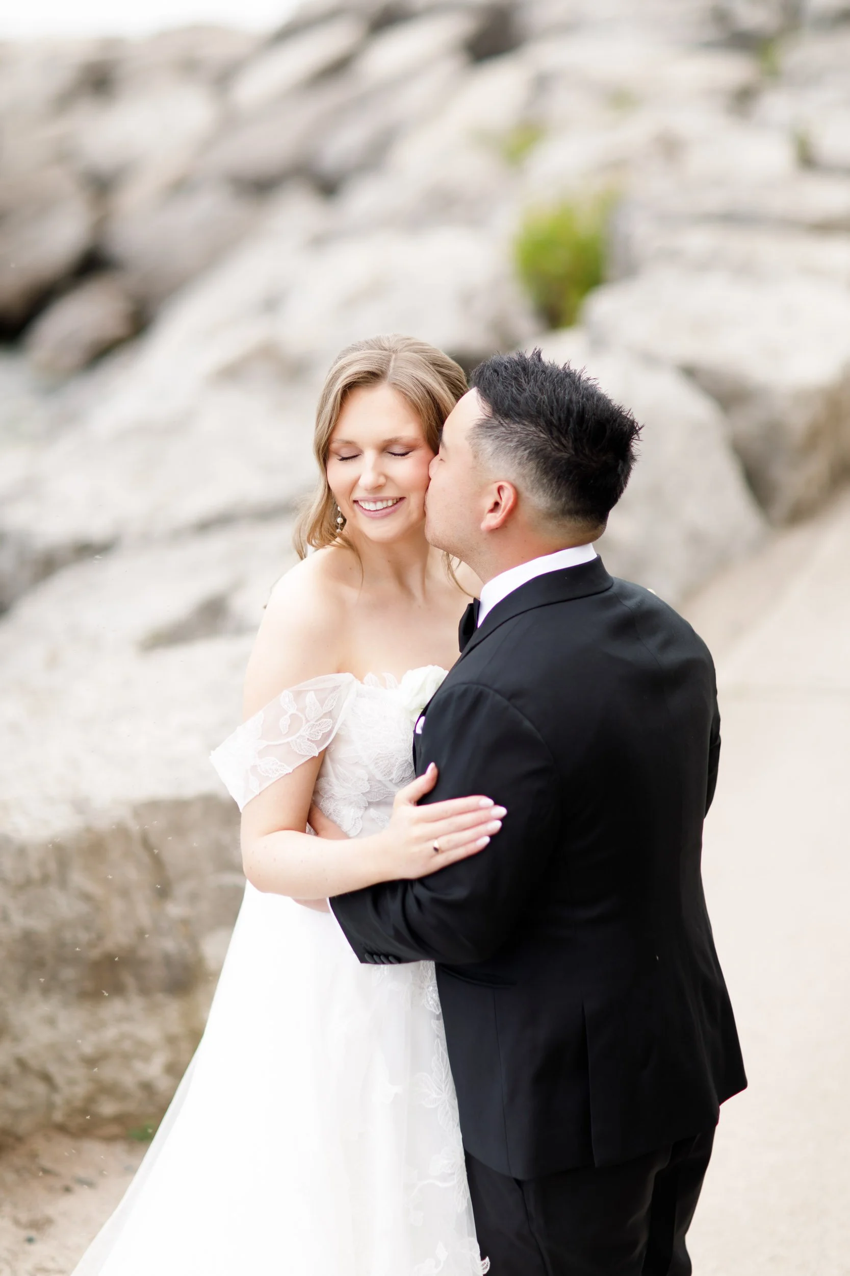 Close up of the bride and groom embracing by the water at the Pearle Hotel in Burlington Ontario