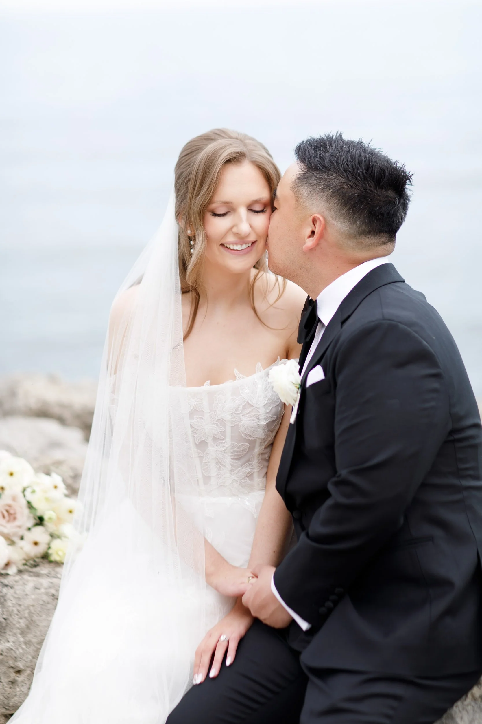 Close up of the bride and groom smiling by the waterfront at the Pearle Hotel in Burlington Ontario