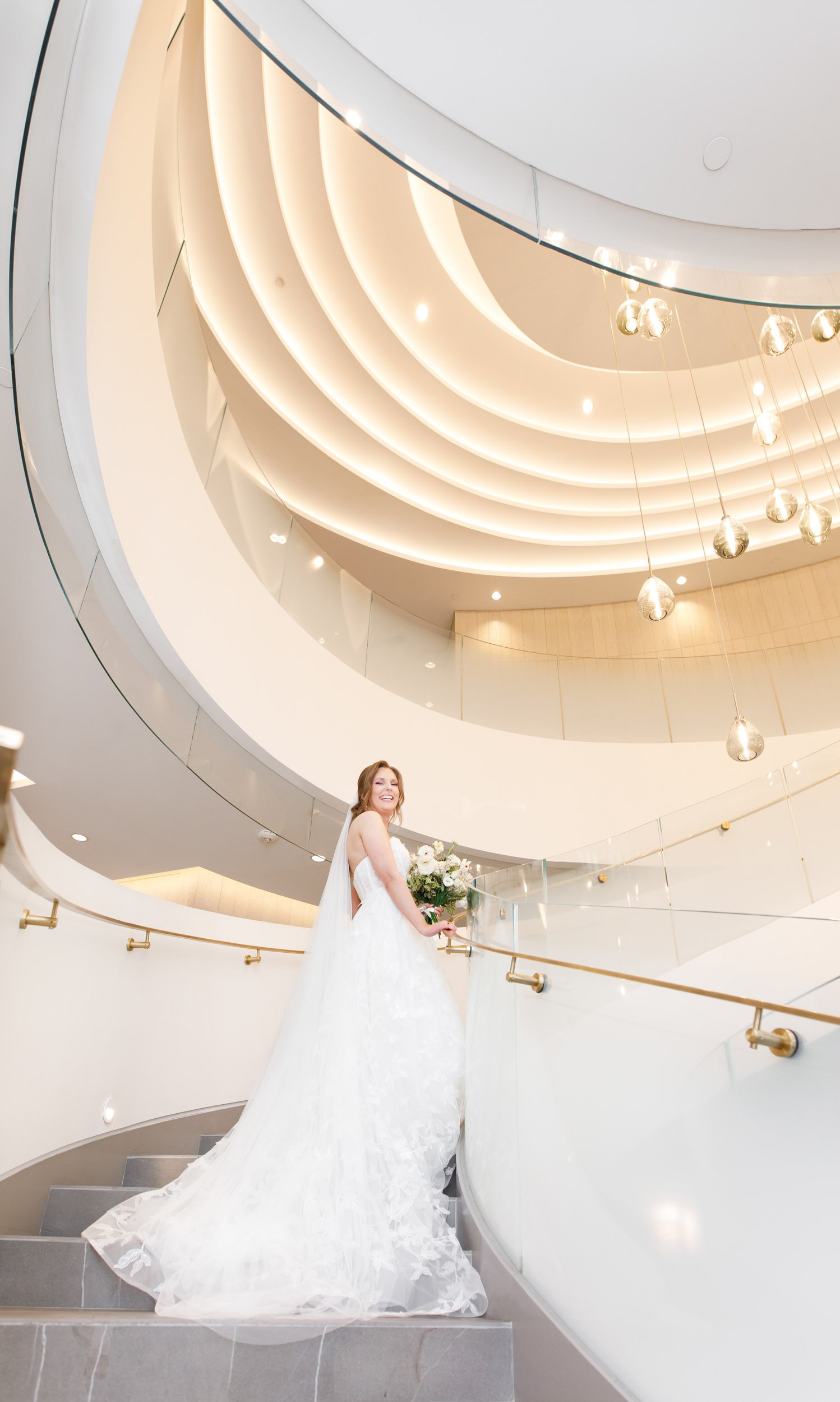 Bride posing on the spiral staircase at the Pearle Hotel in Burlington Ontario
